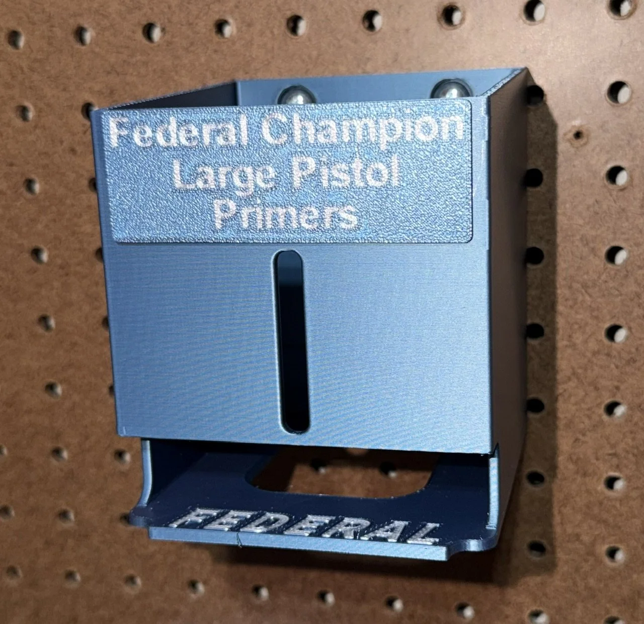 Federal Champion Large Pistol Primer Pack Organizer mounted on a pegboard for reloading bench storage.
