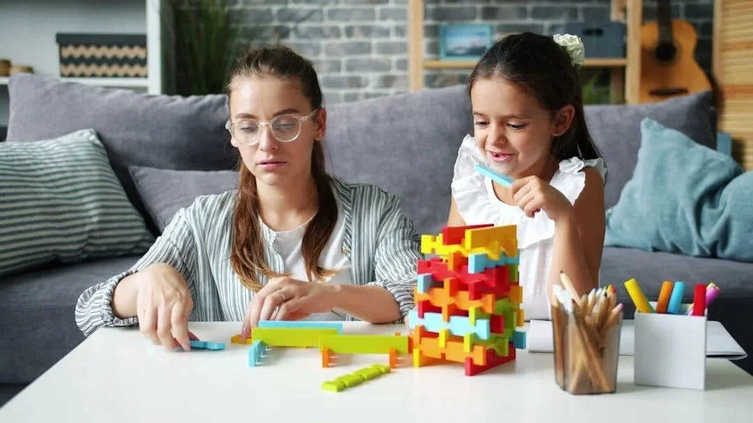 Young girl in a tutoring session working with colorful blocks.