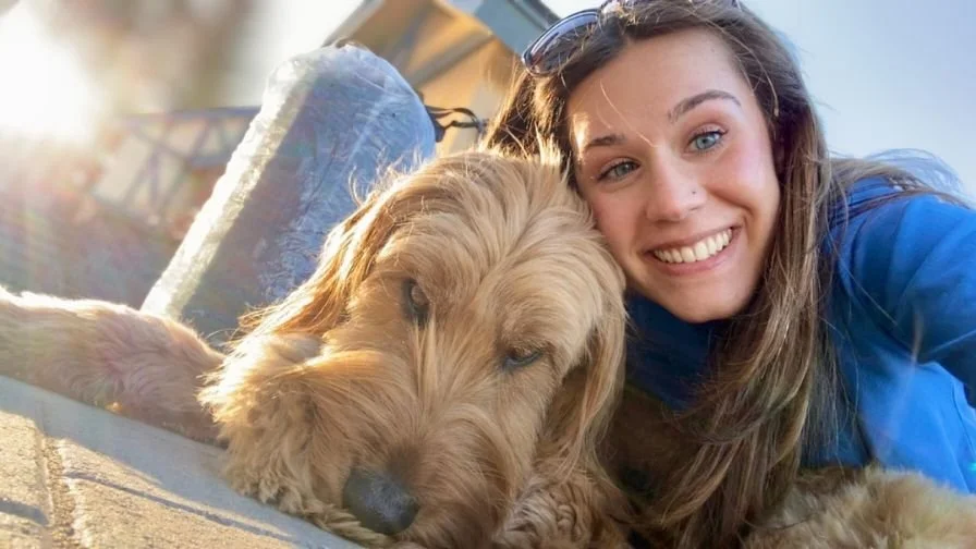 Close up of Audrey and her goldendoodle Micah.