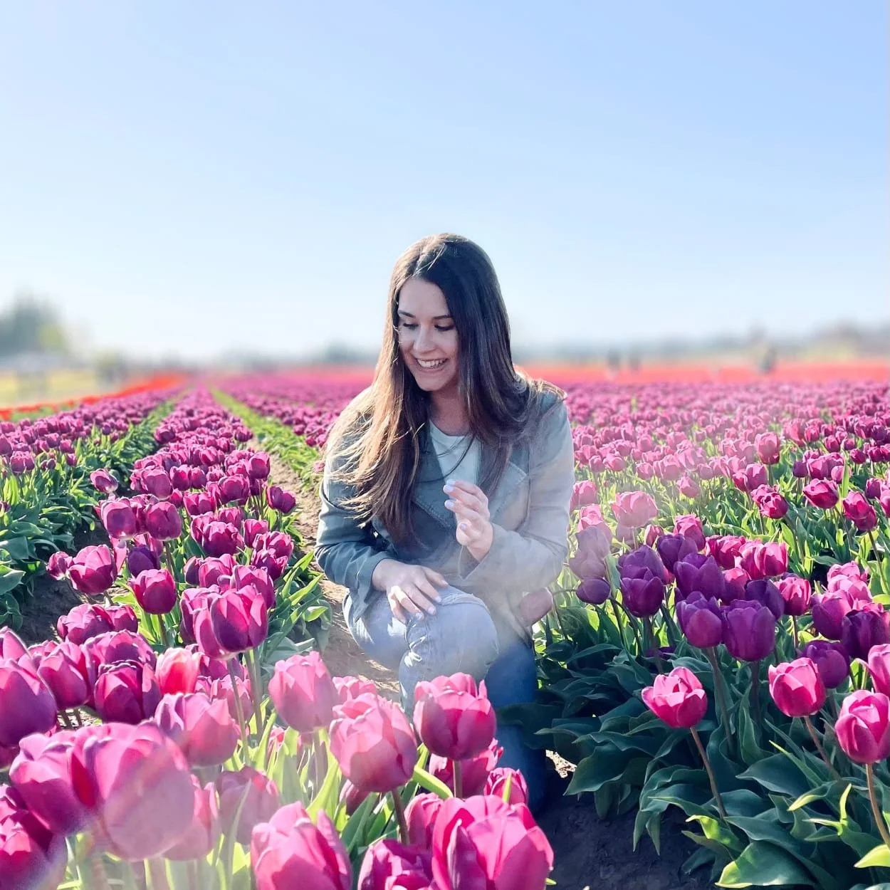 Audrey Muller in a field of pink tulips.
