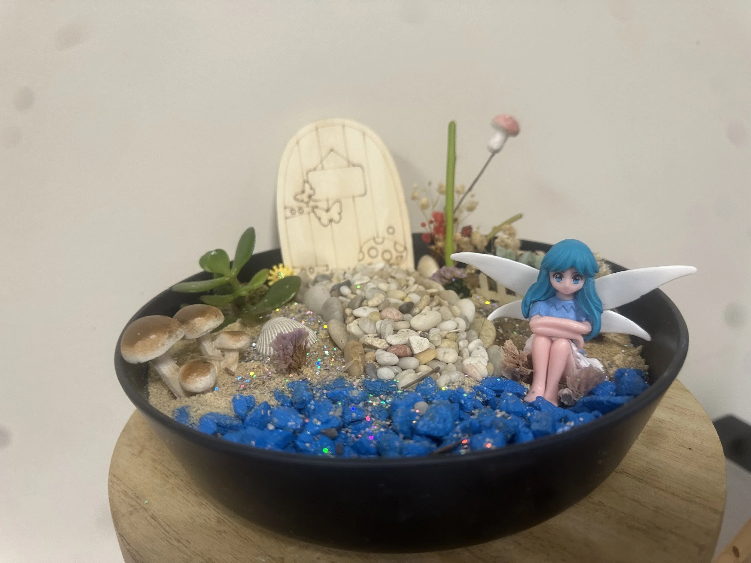 Fairy garden example with different vessel, fairy & products.