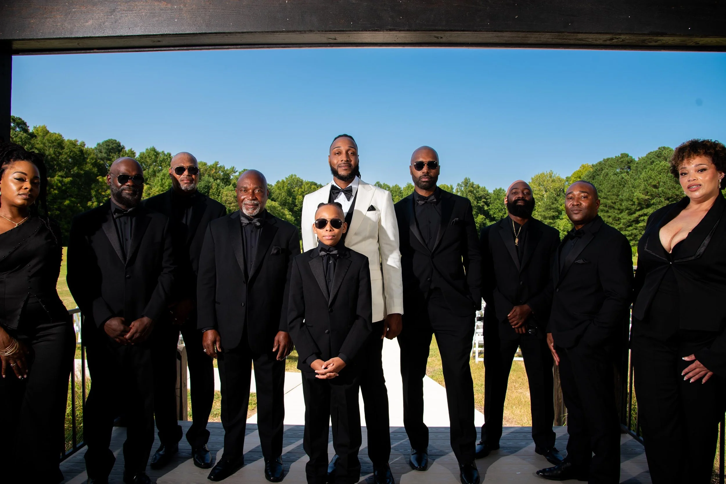 a wedding party standing outside