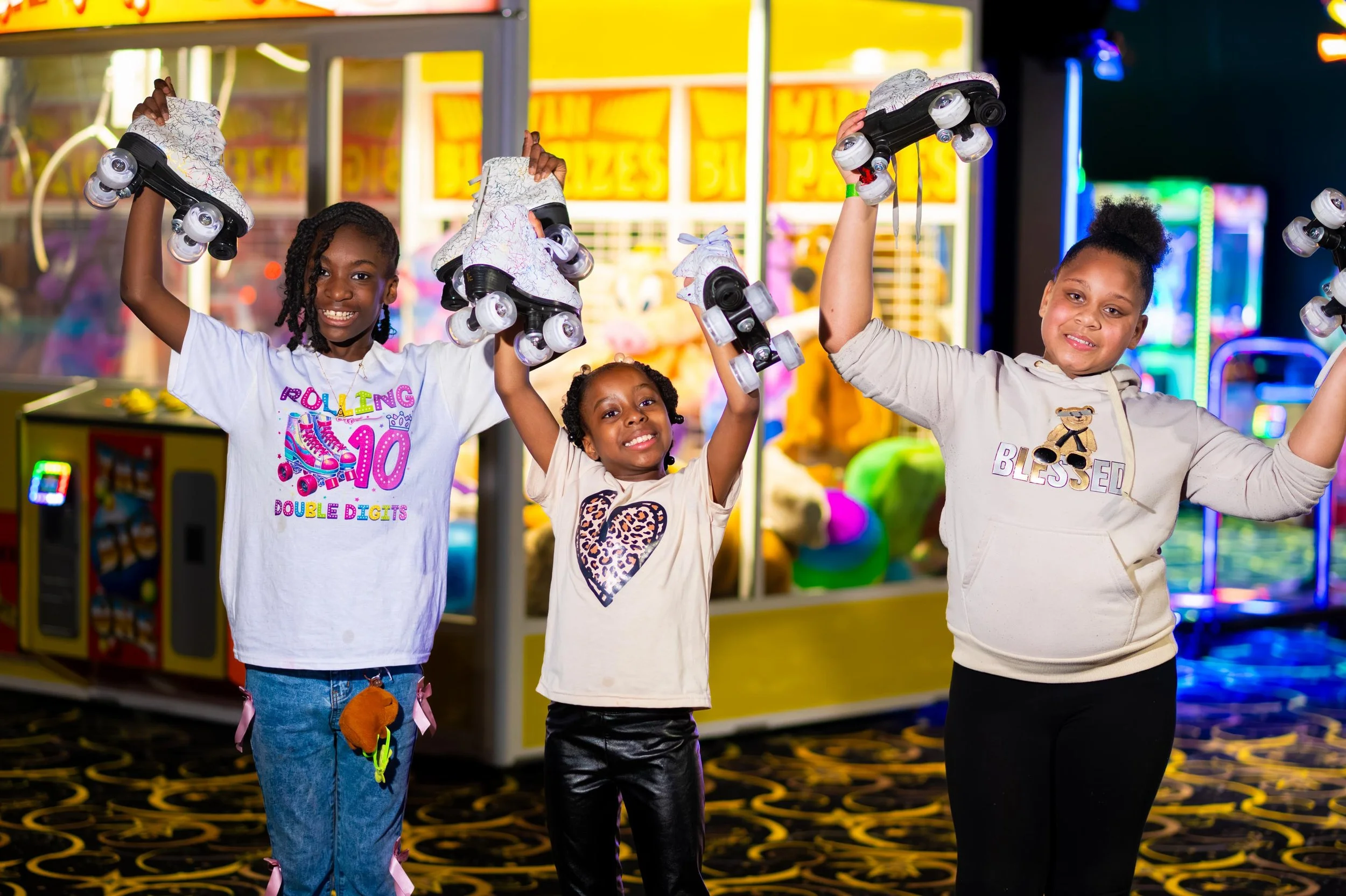 Kids holding skates in the air celebrating