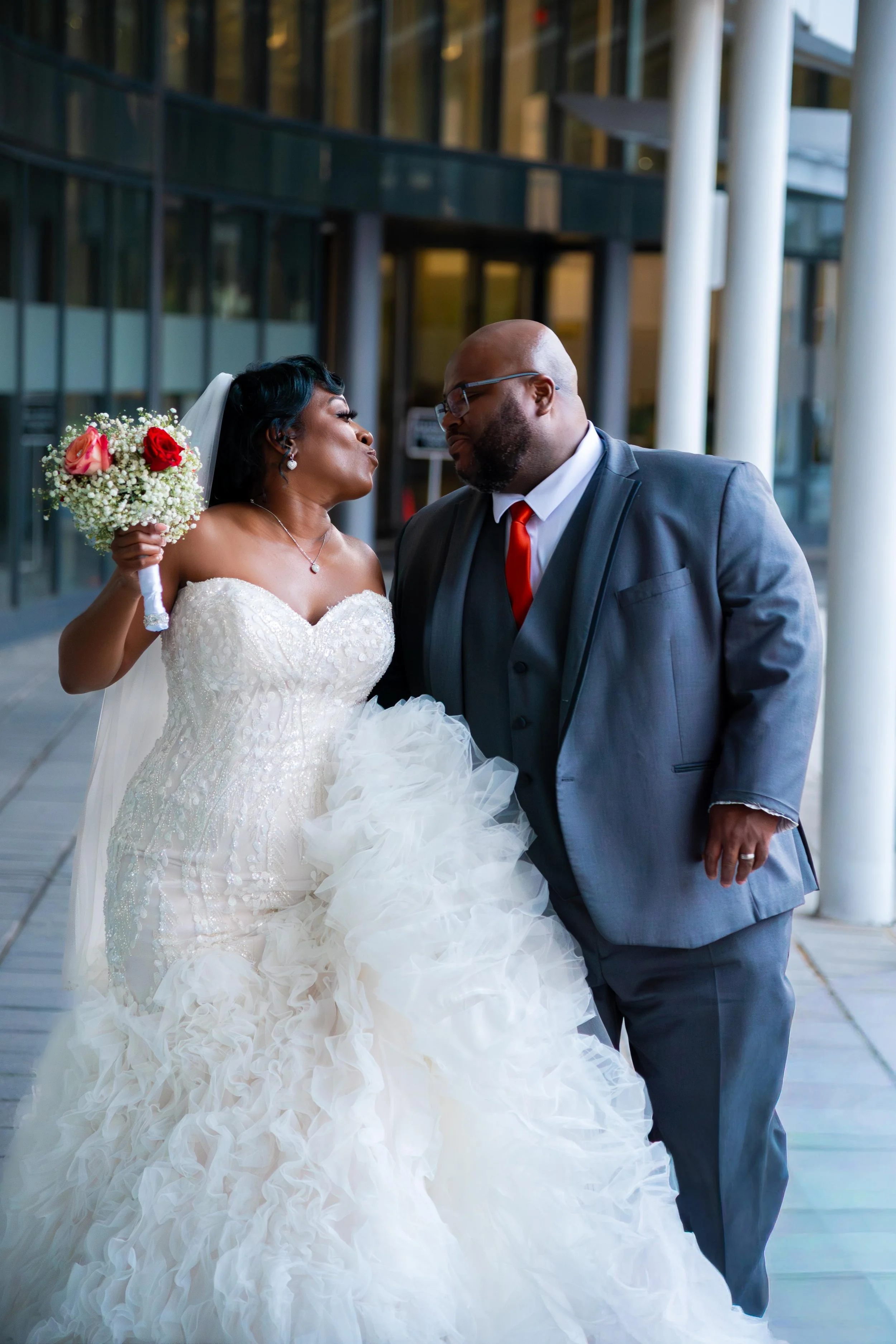 New husband and wife kissing in front of the World Trade Center in Norfolk VA