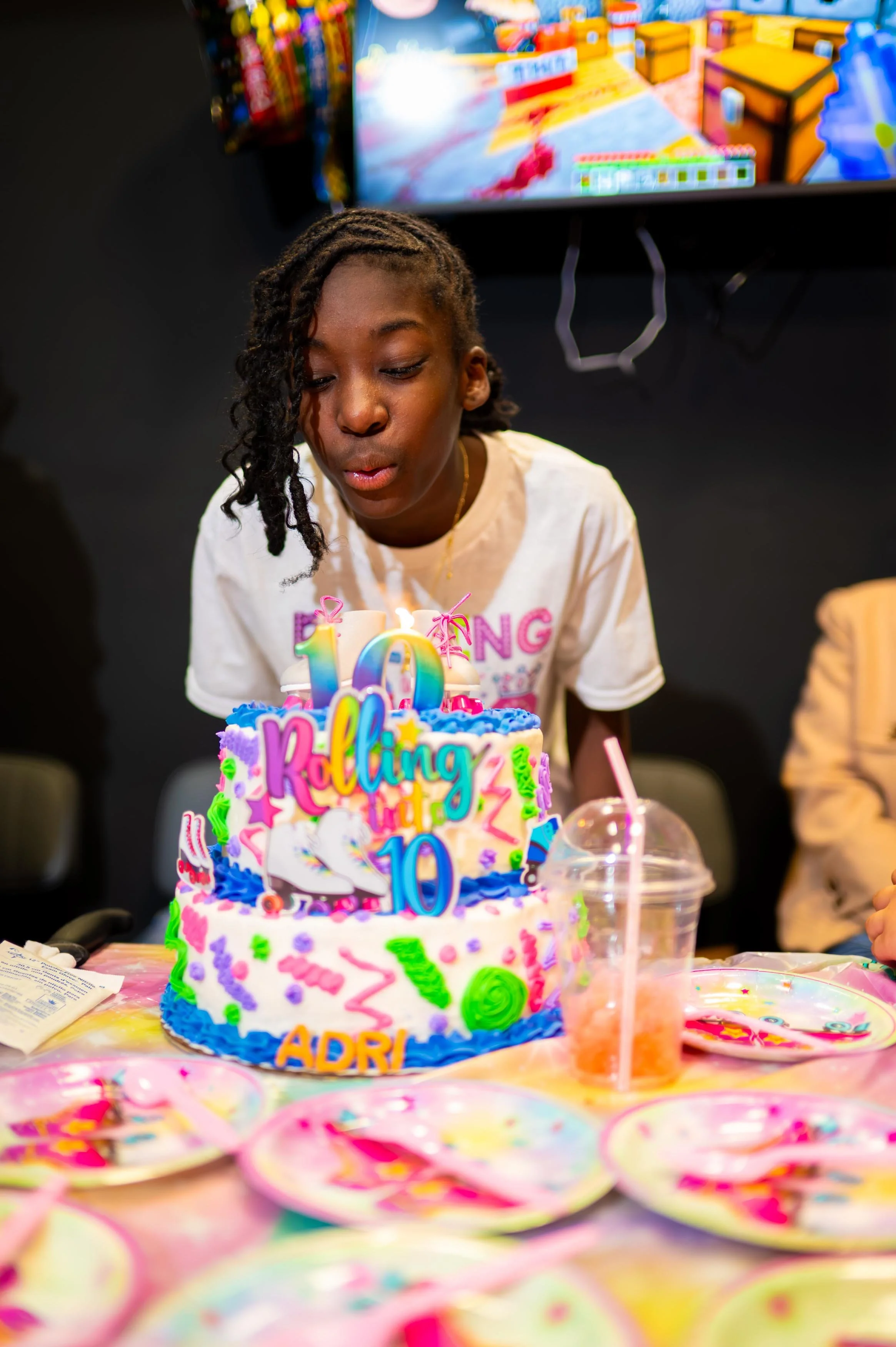kid blowing out candle at birthday party
