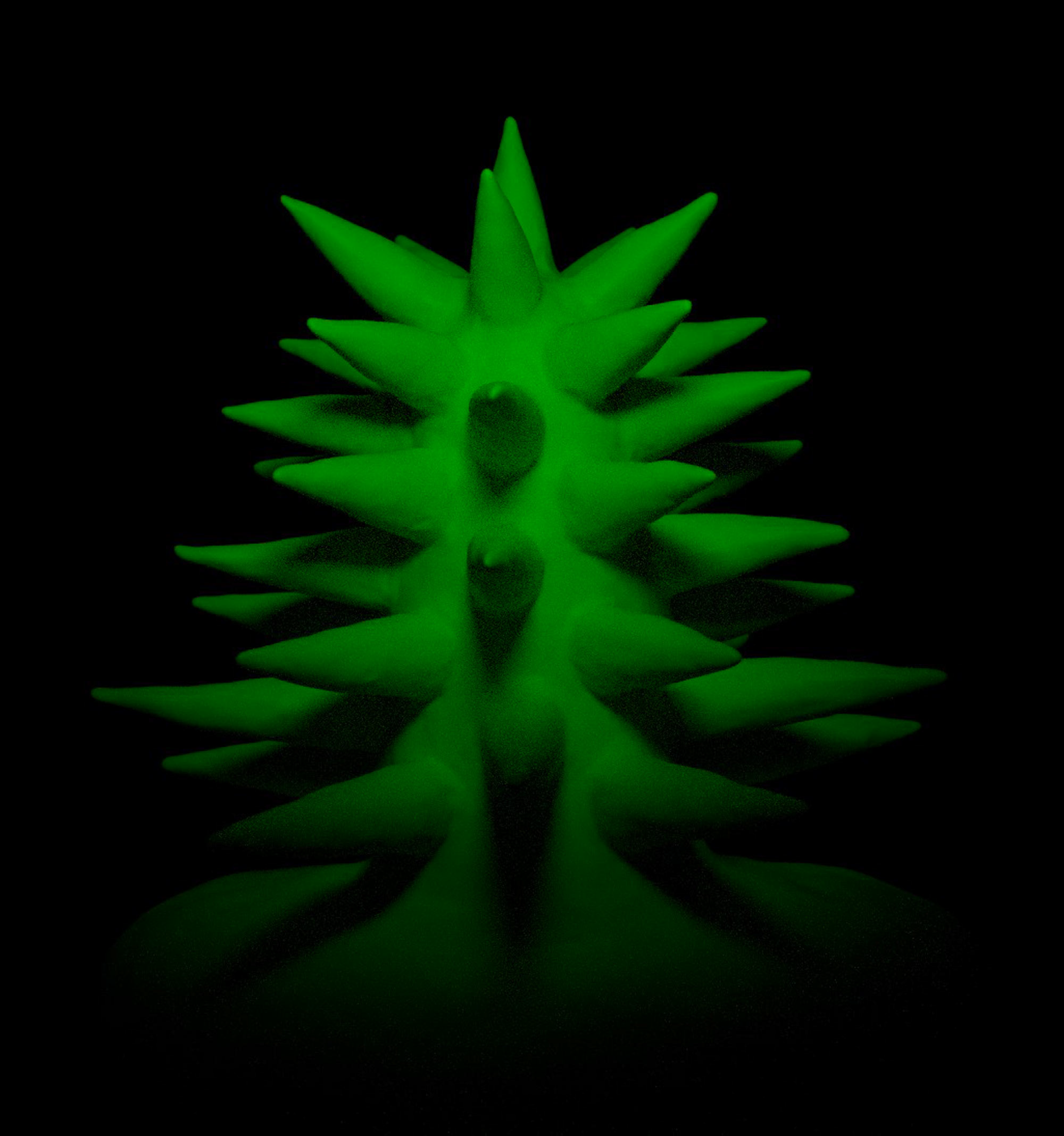Bright green spiky object on reflective black surface, glowing in the dark.