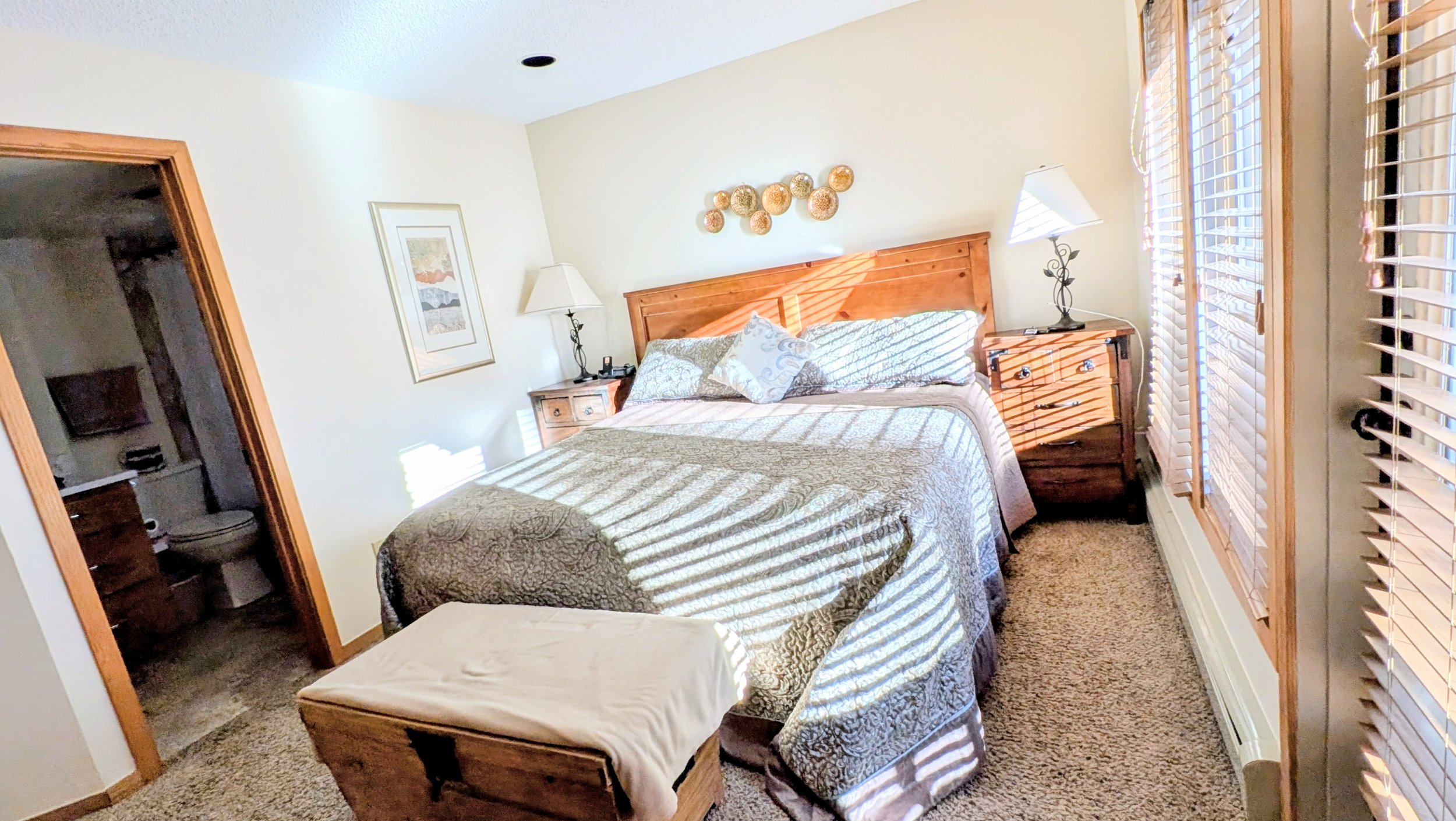 Primary bedroom with deck overlooking Ten-Mile Creek