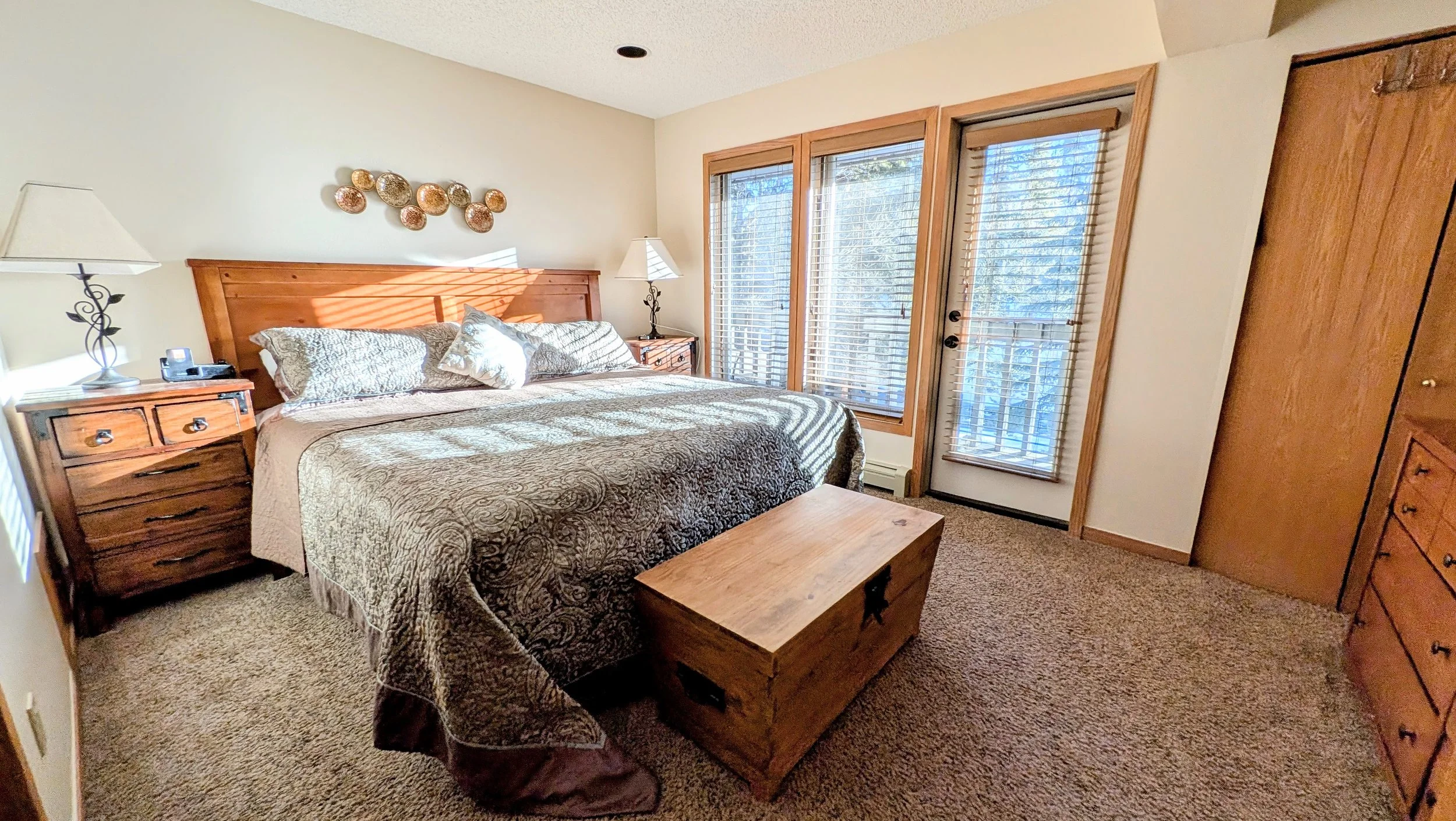 Primary bedroom with deck overlooking Ten-Mile Creek