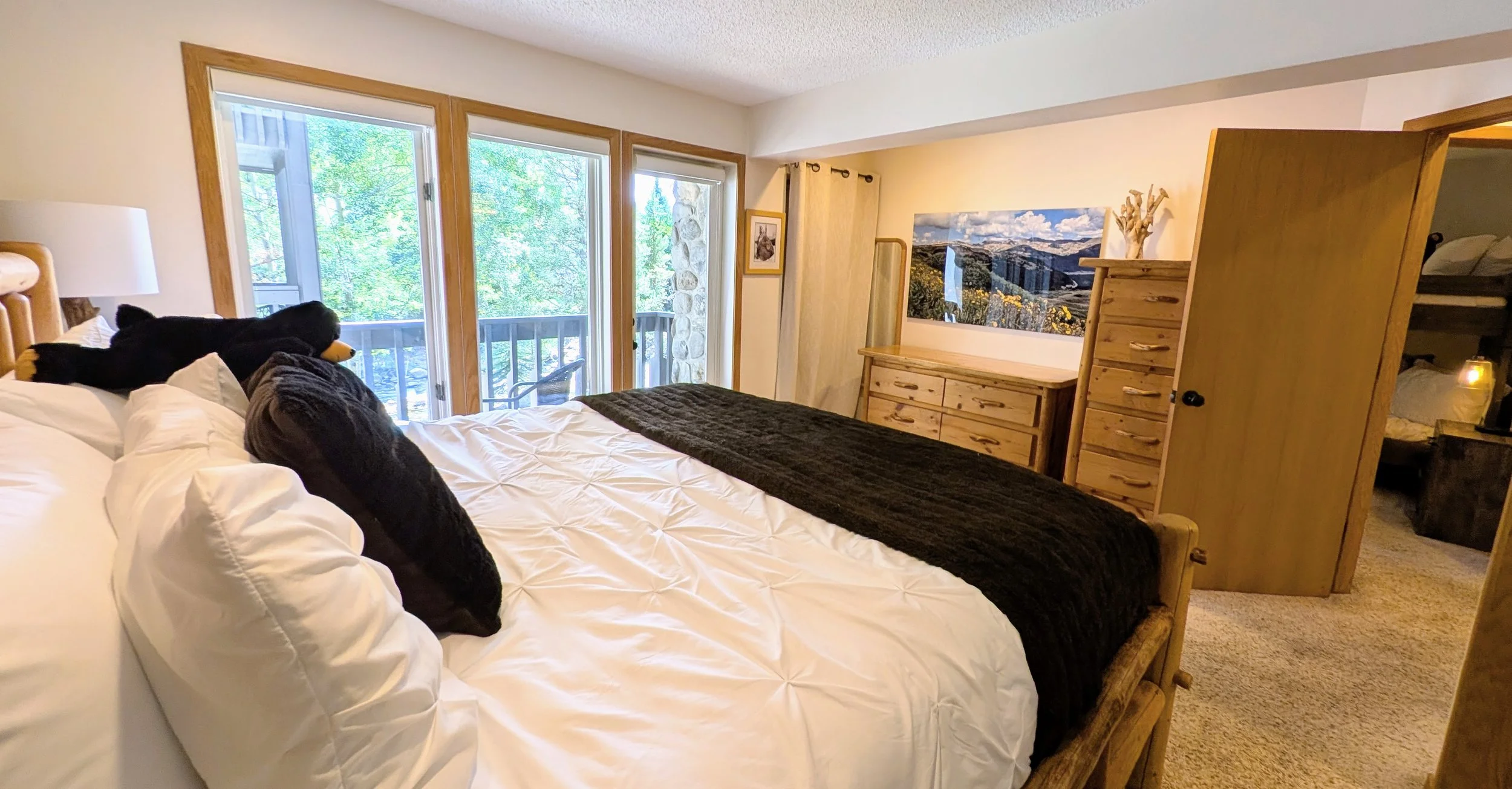 Primary bedroom with deck and gorgeous view of Ten Mile Creek