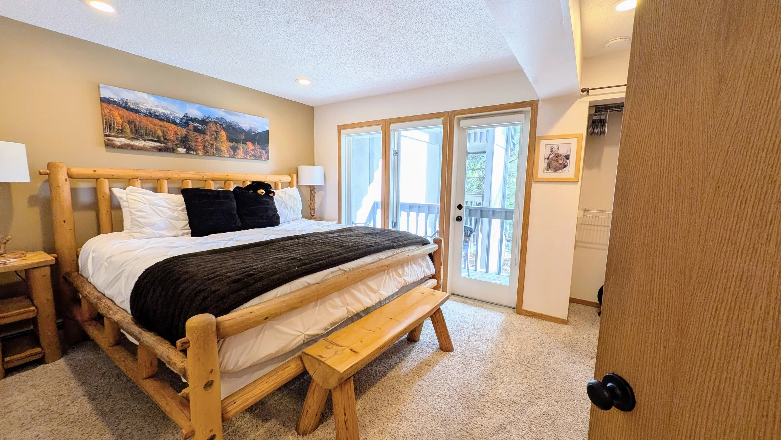 Primary bedroom with deck and gorgeous view of Ten Mile Creek