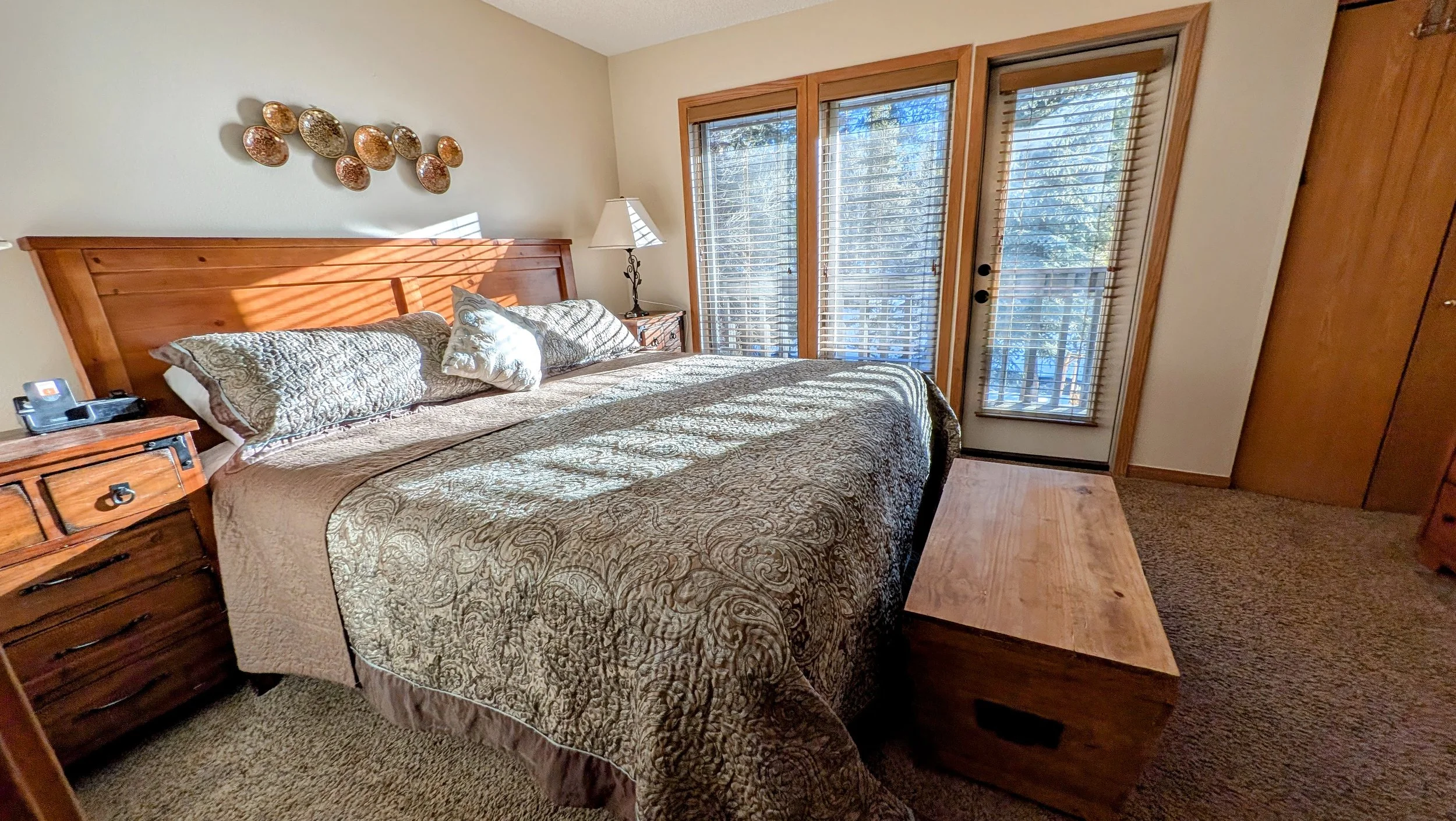 Primary bedroom with deck overlooking Ten-Mile Creek