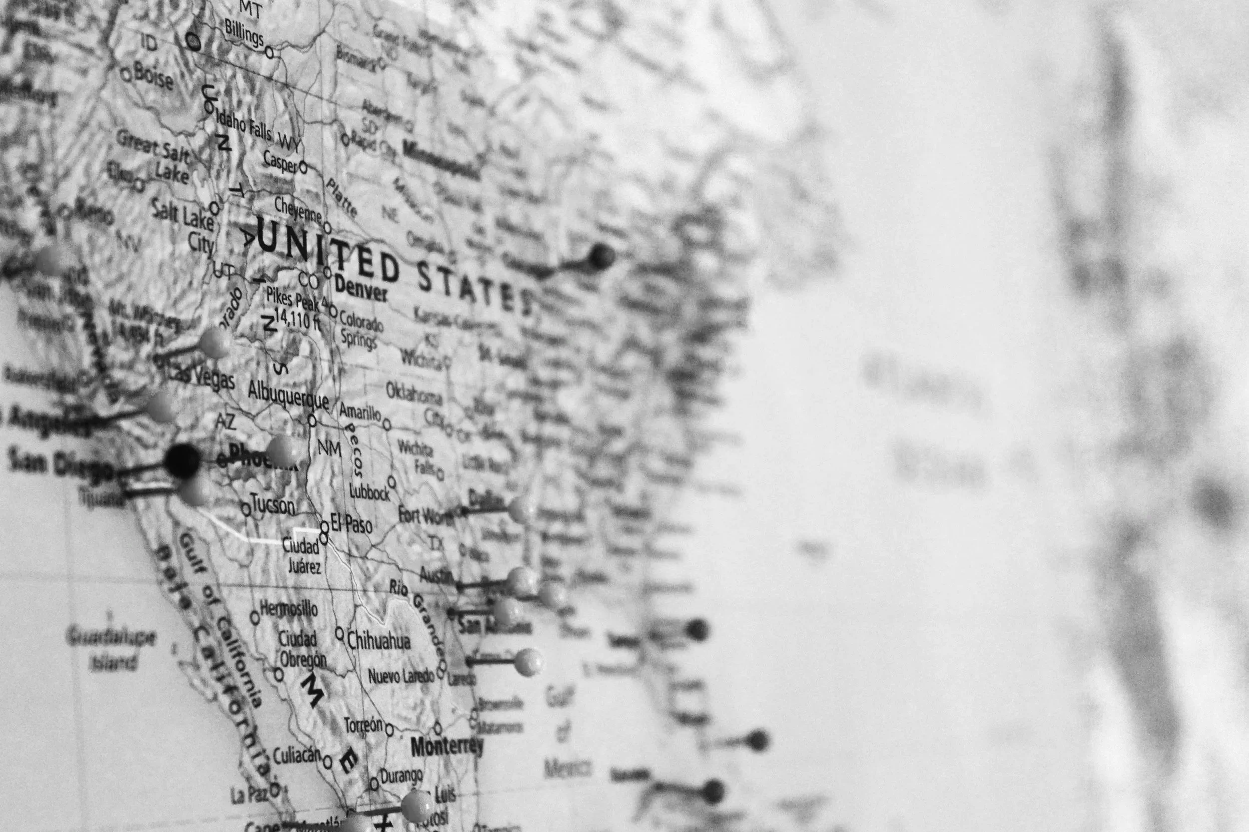 close up of photo of map of United States of America with push pins