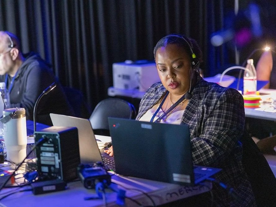 Photo of Lauren-Michelle Smith backstage at a live event in production wearing a comms headset