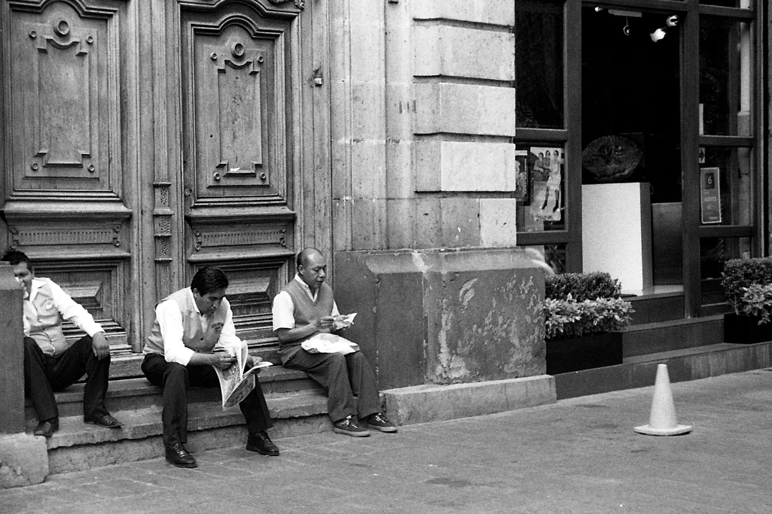 Black and white photo of restaurant workers taking a break on steps