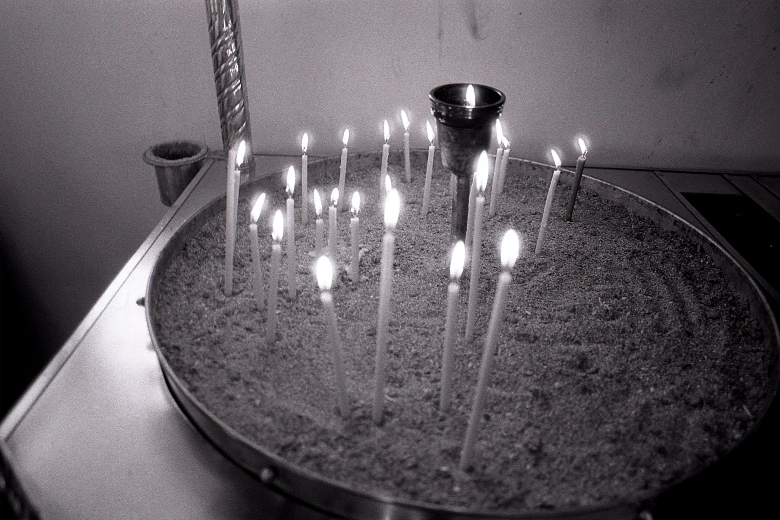 A Hanukkah menorah placed on a table with lit candles and a lit menorah in the center.