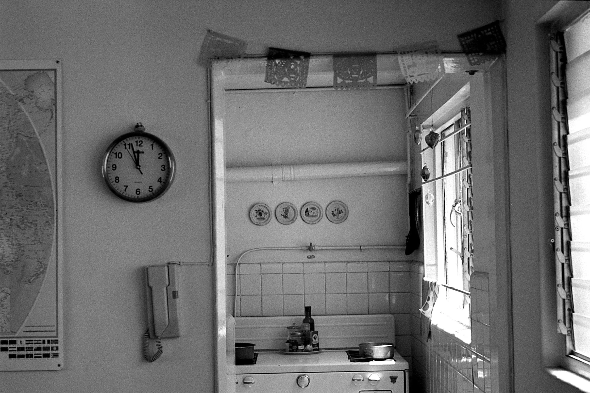 Black and white photo looking into a kitchen