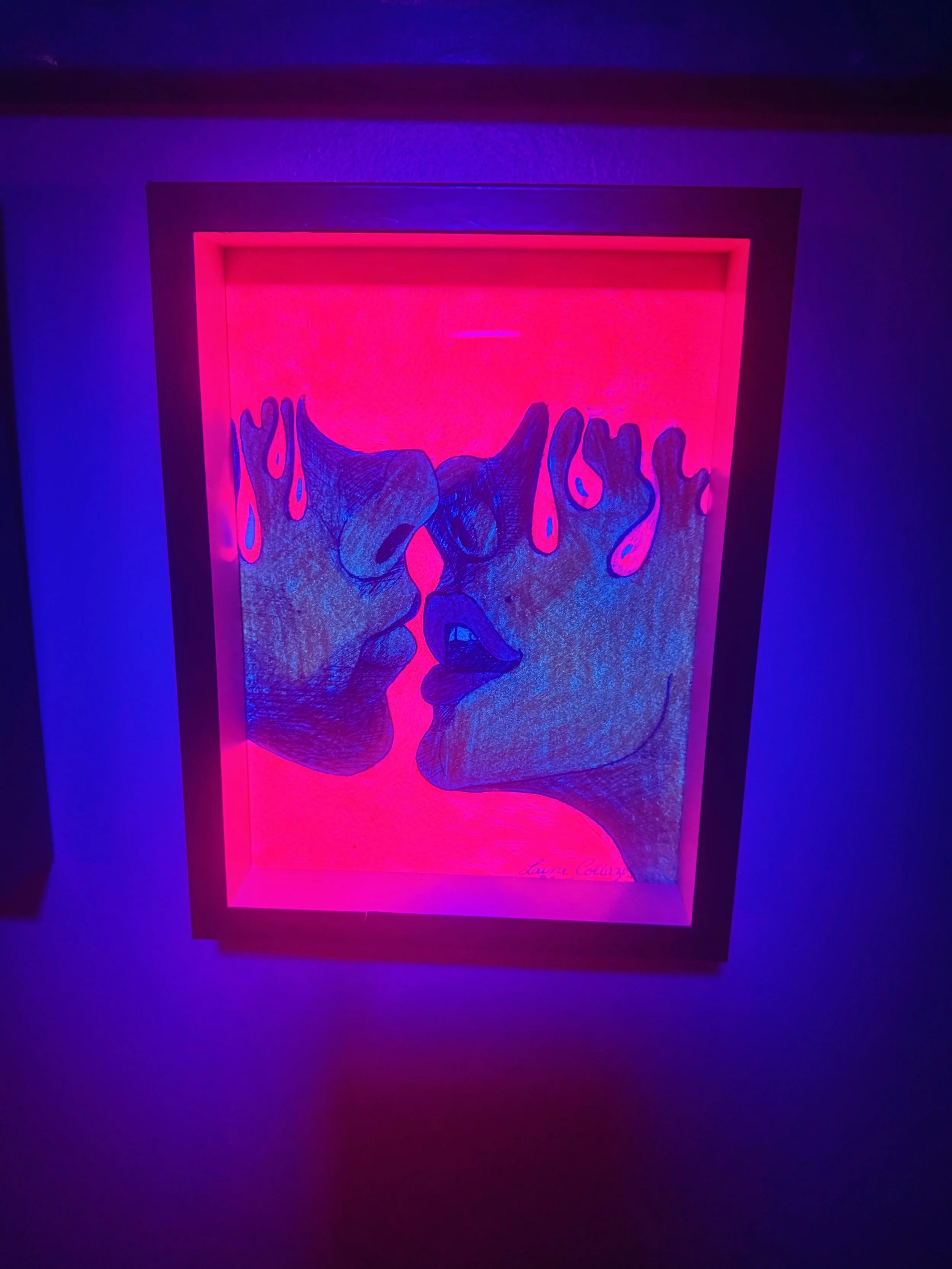 Neon art of two faces close together, with lips almost touching, under pink and purple lighting.