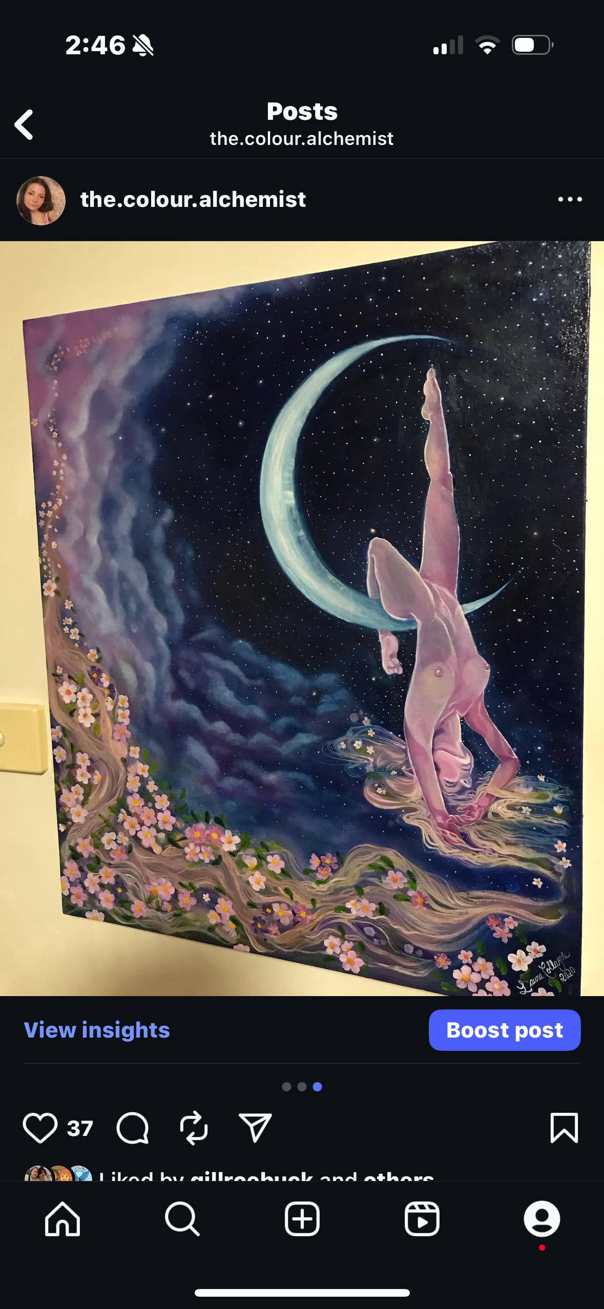 A woman performing a handstand on water below a crescent moon and starry night sky, with a tree and pink flowers in the foreground.