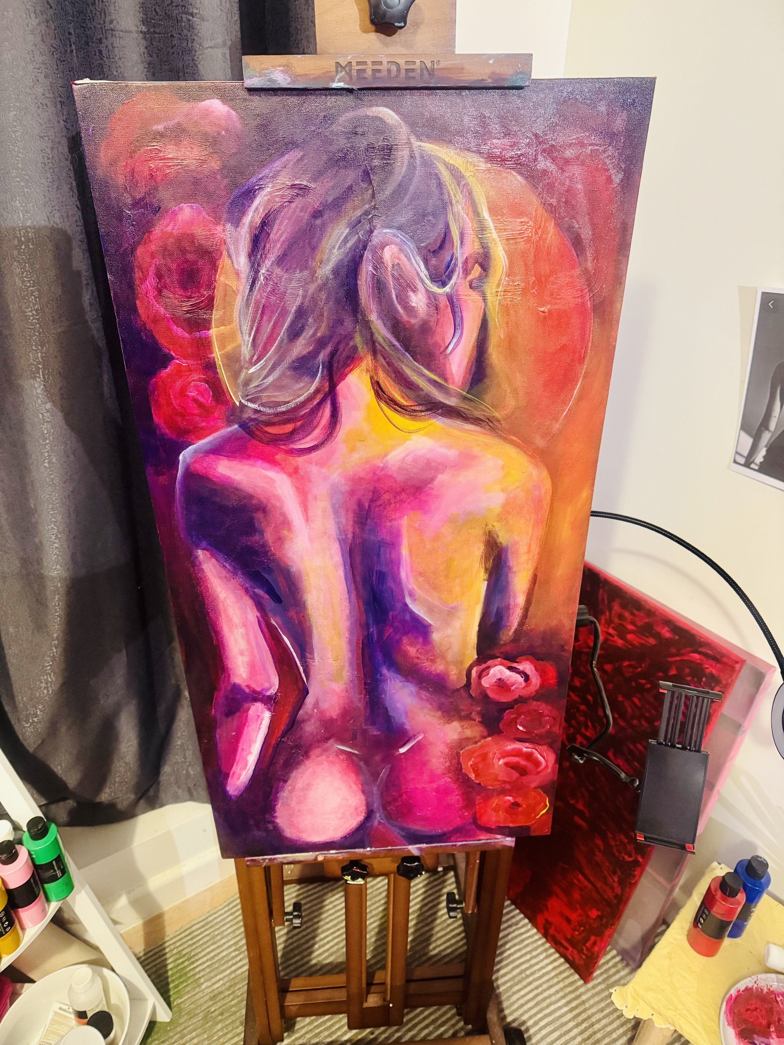 Colorful painting of a topless woman with long hair, seen from behind, with roses and warm colors.