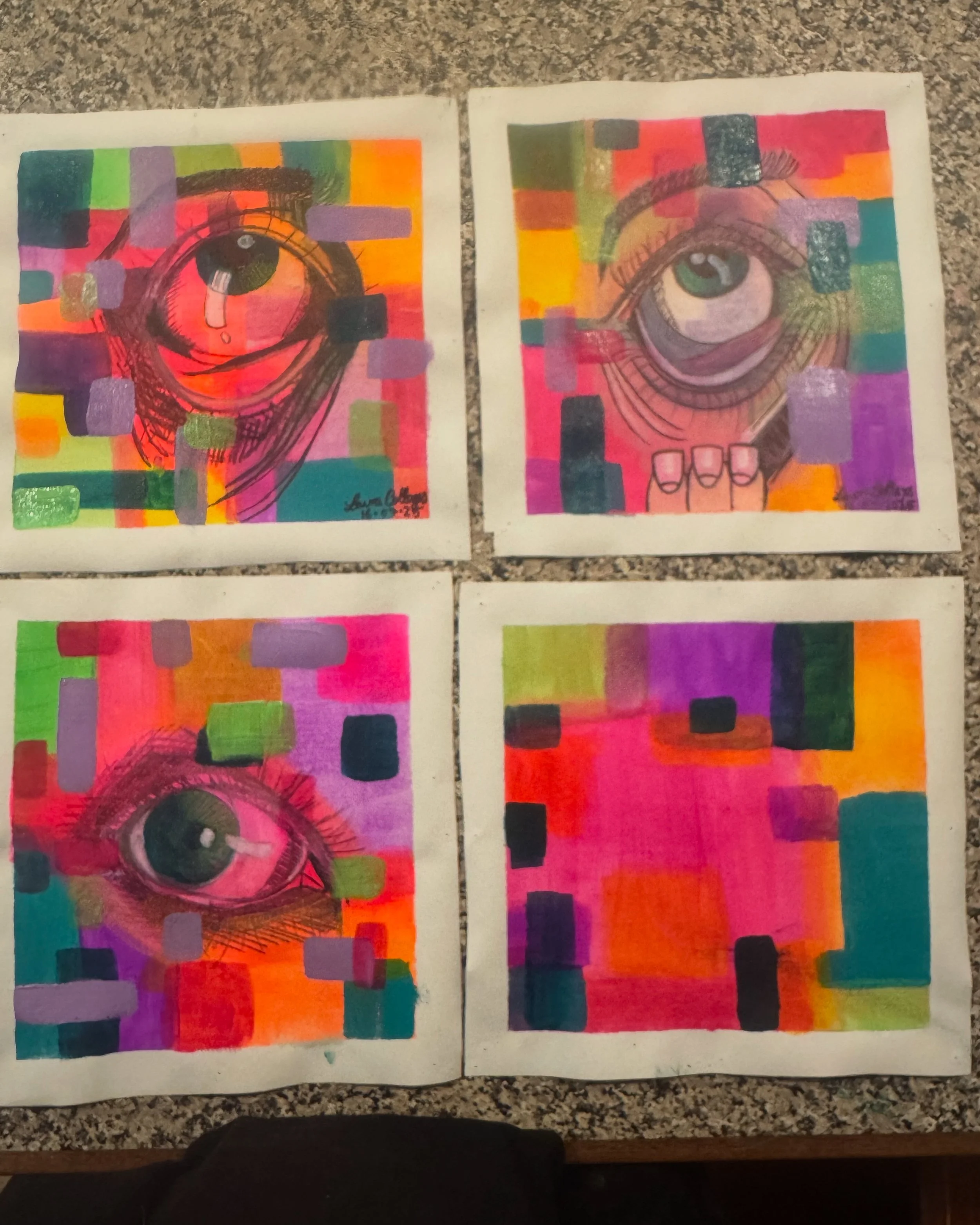 Four colorful drawings of eyes on paper with abstract backgrounds featuring squares and rectangles in various bright colors.