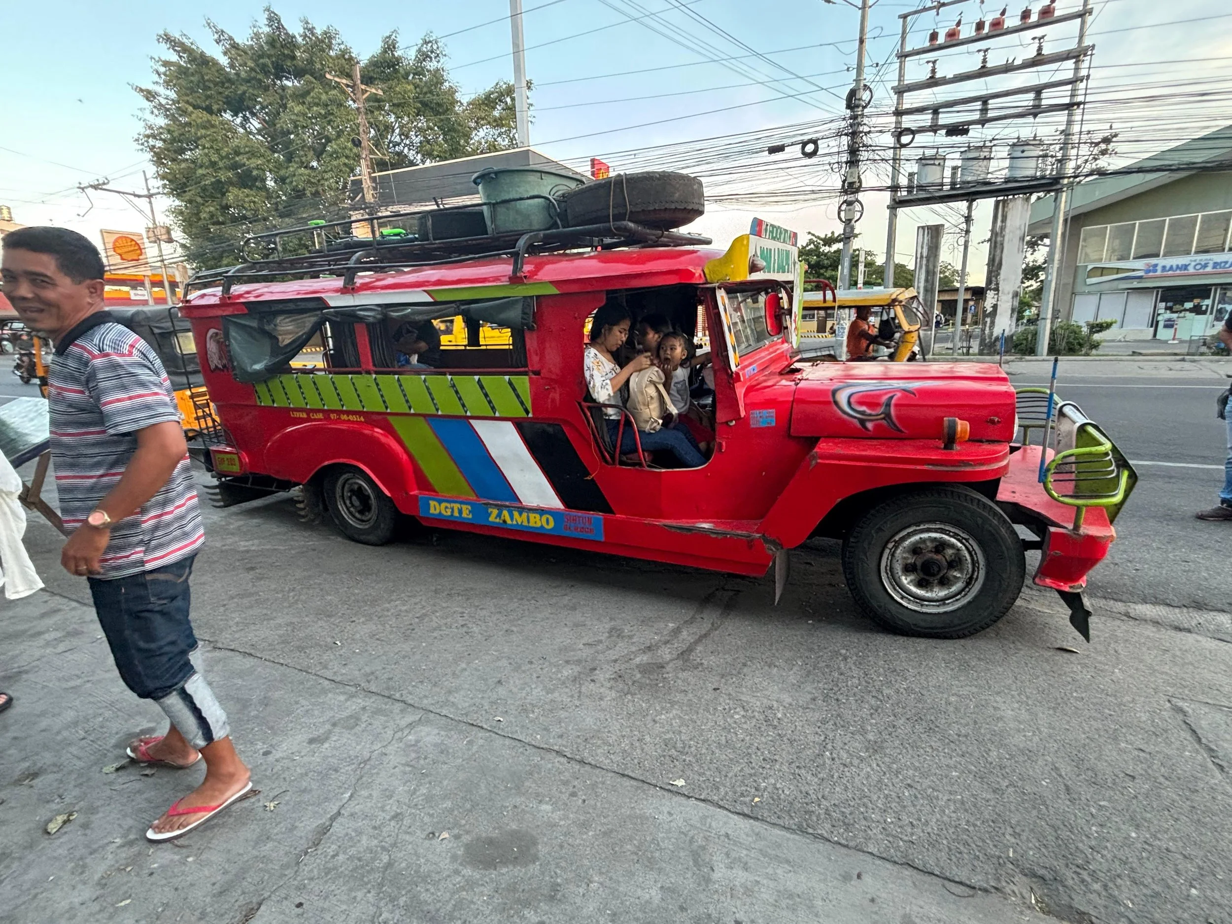Roderick's family sits in the front of his jeepney