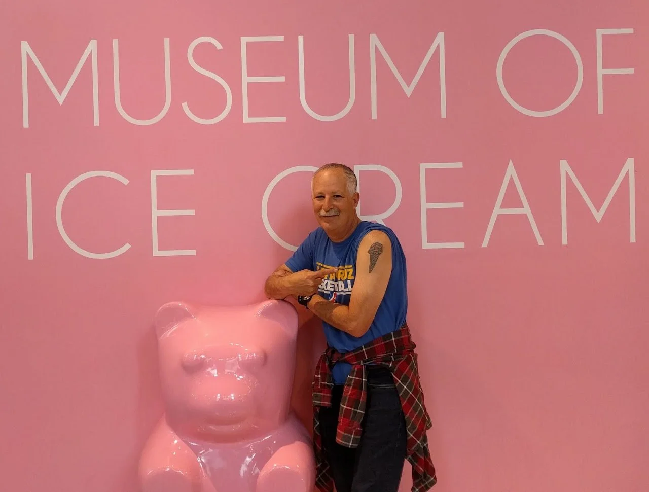Don posing at Ice Cream museum with ice cream cone tattoo
