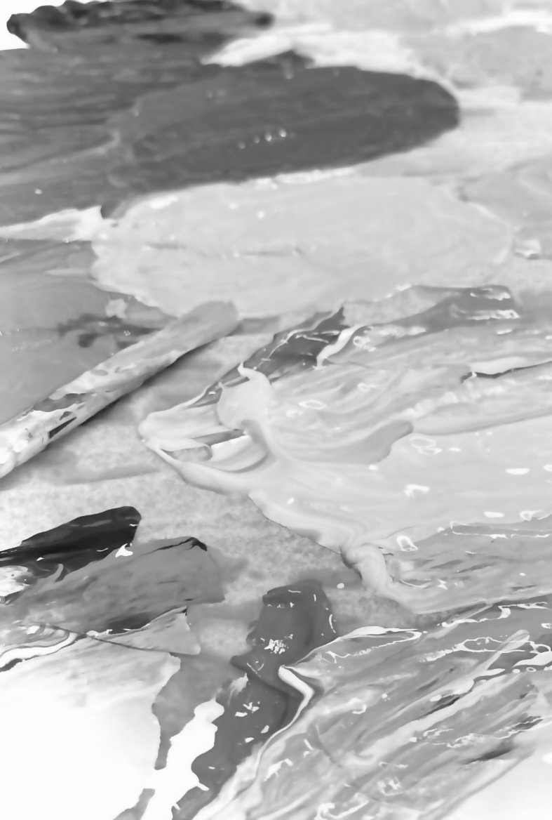 Close-up of paint being poured and mixed on a surface, creating abstract swirls and patterns.