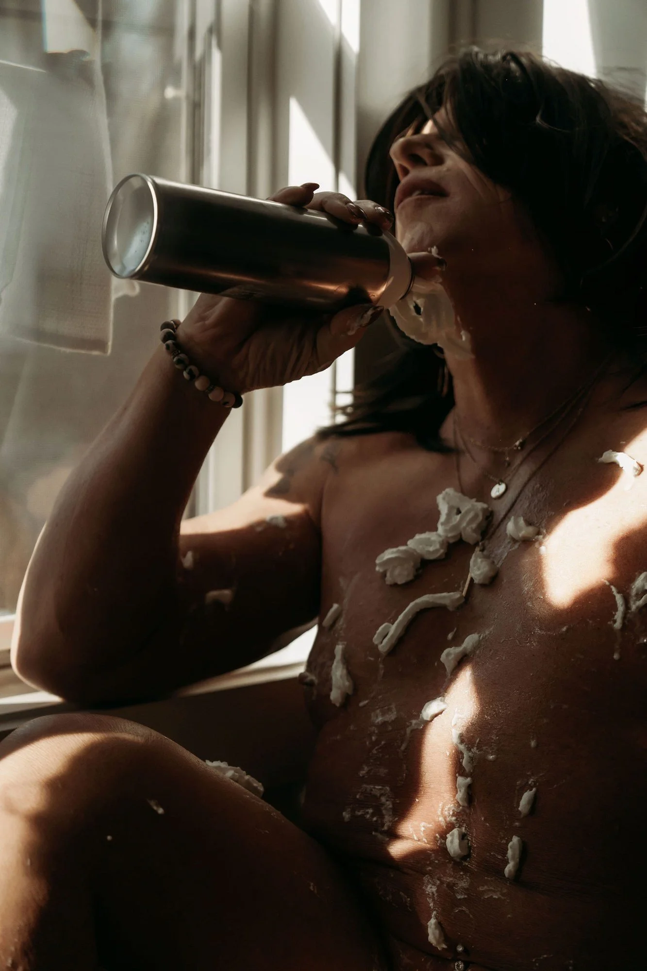 Woman drinking from a tumbler with whipped cream on her chest, Sticky Sweet add-on set by Nashville boudoir photographer Holly Douglas & Co