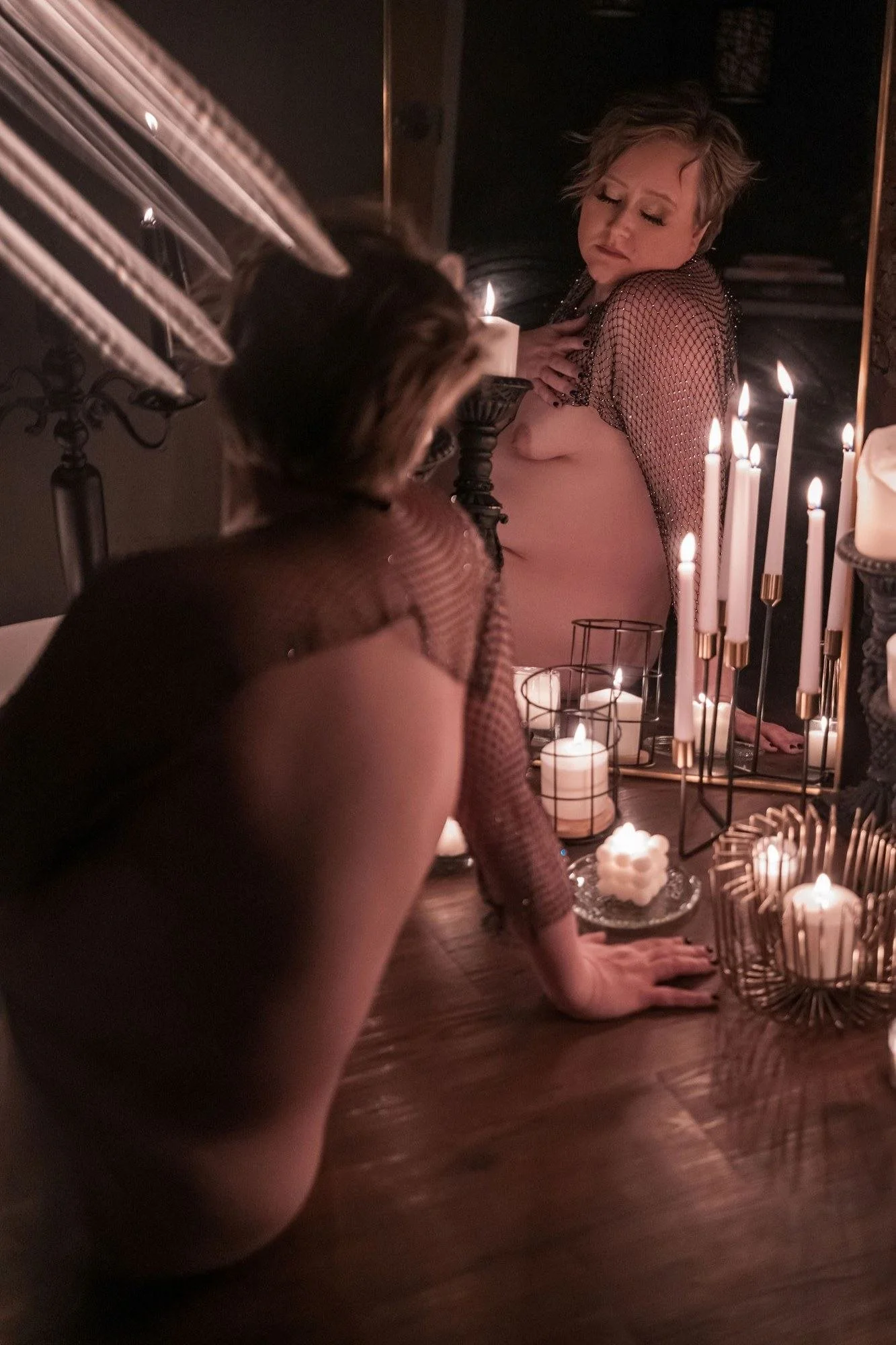 Woman kneeling before a mirror with lit candles at her feet, Candle Light add-on set in Nashville, TN