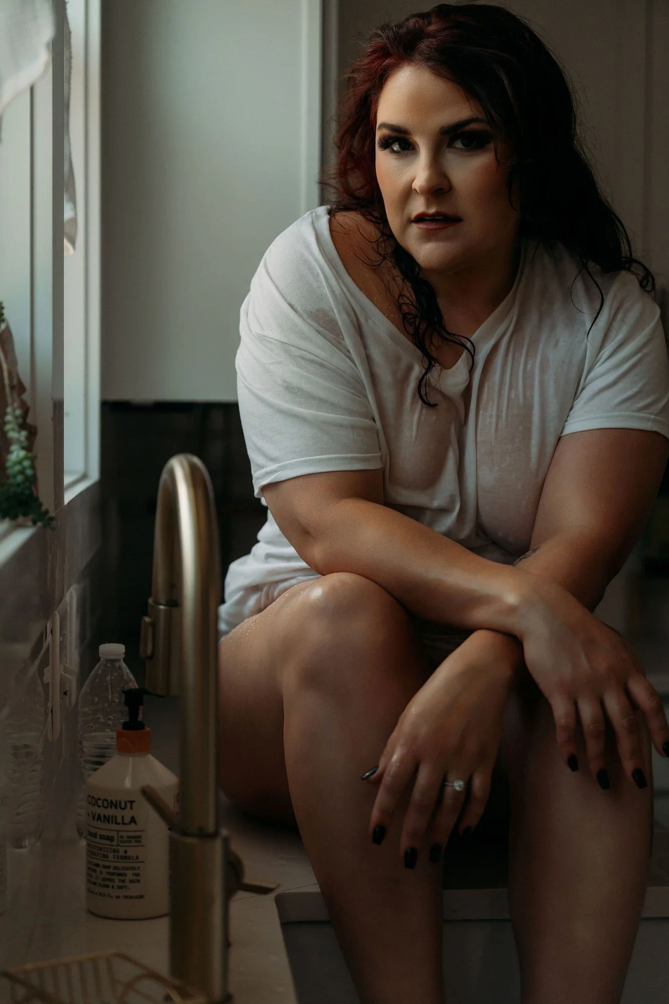 Woman in a soaked white t-shirt sitting on the kitchen sink, Nashville boudoir add-on sets