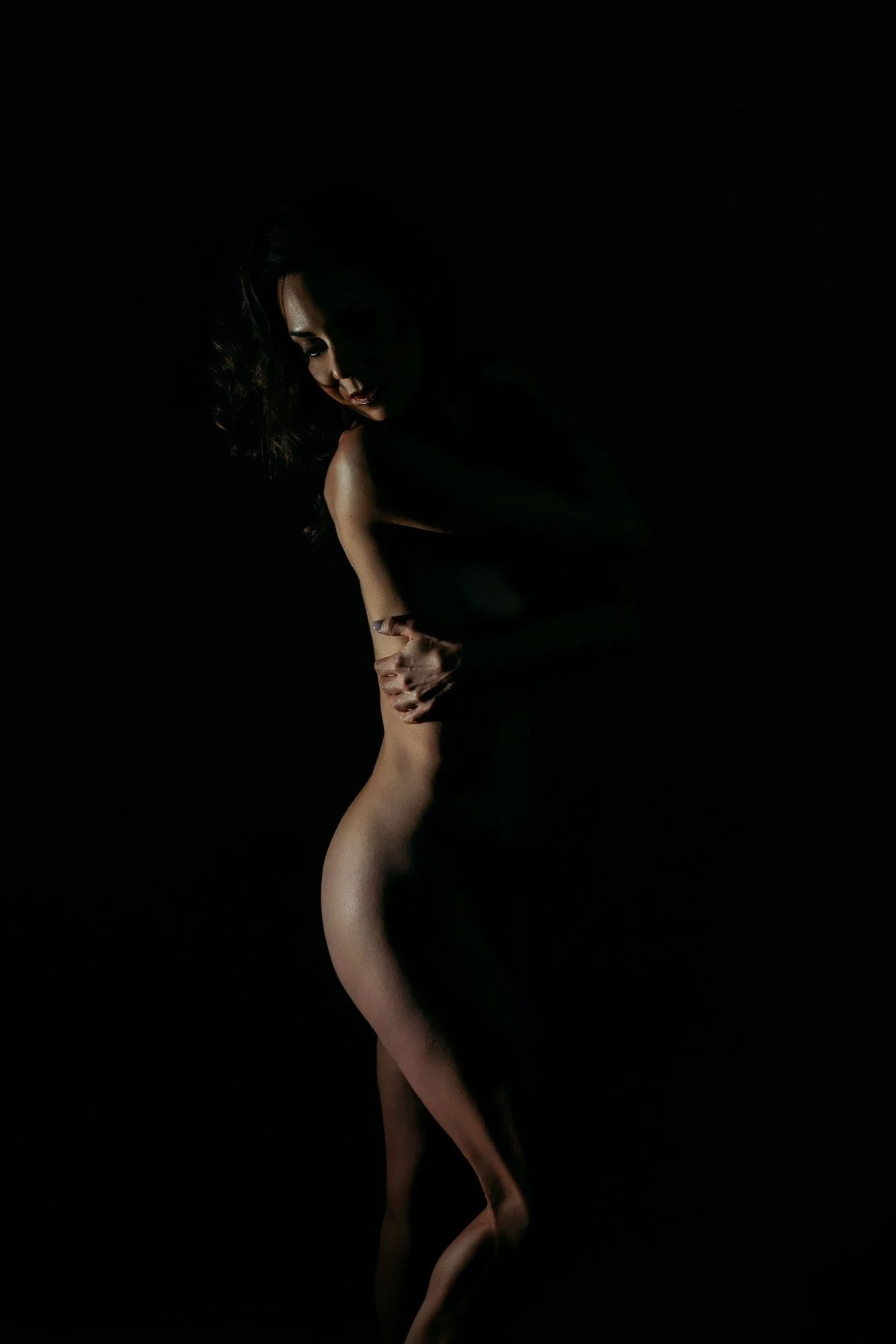 Woman's silhouette in a single beam of light, Nashville boudoir add-on sets
