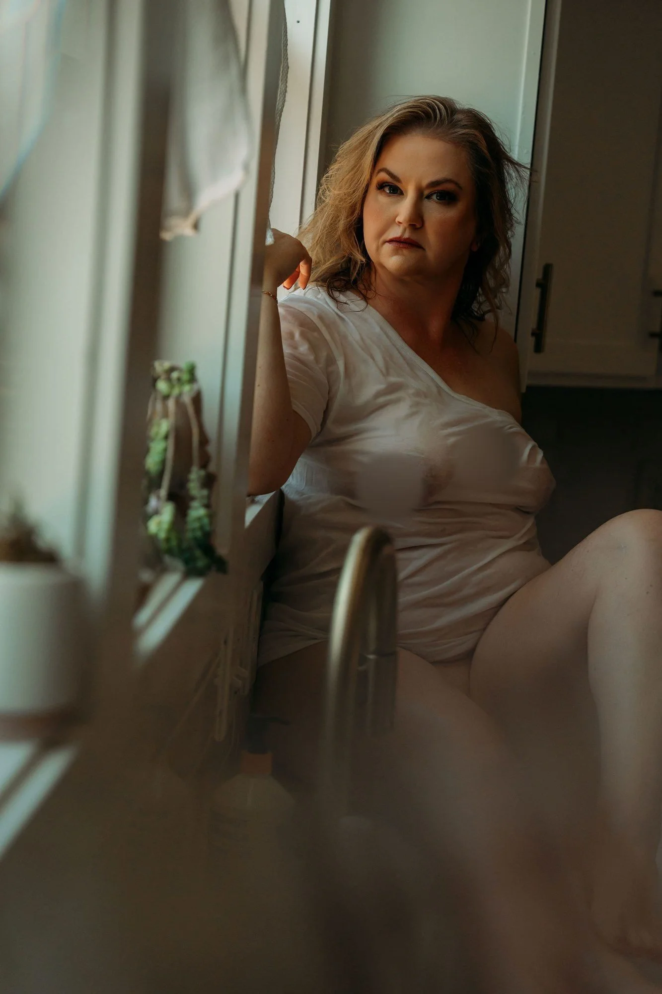 Woman in a wet t-shirt glancing over her shoulder beside the window, Wet T-Shirt boudoir photos, Nashville
