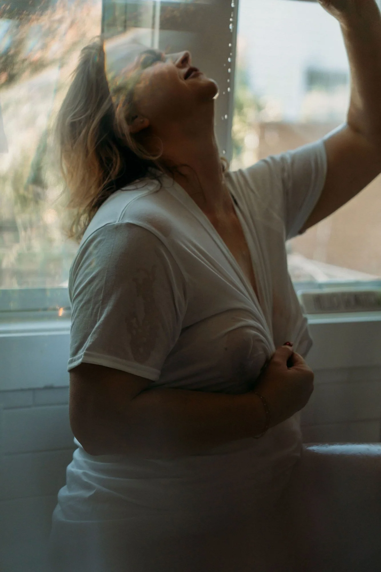 Woman with water running over her face in a white t-shirt, Wet T-Shirt add-on set by Nashville boudoir photographer Holly Douglas & Co