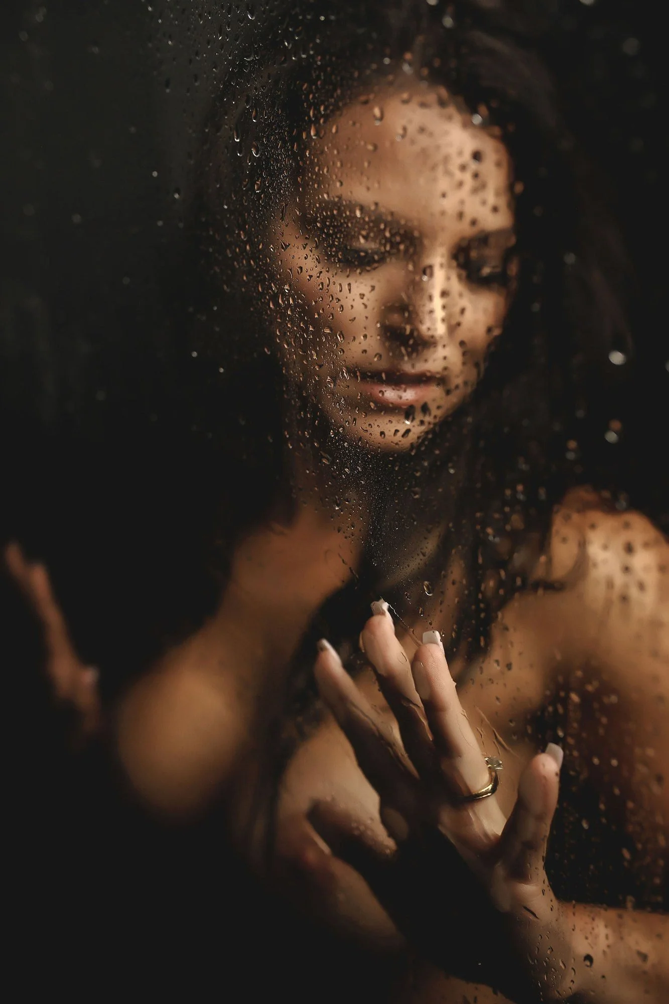 Woman looking down behind rain-spotted shower glass, Shower add-on set by Nashville boudoir photographer Holly Douglas & Co