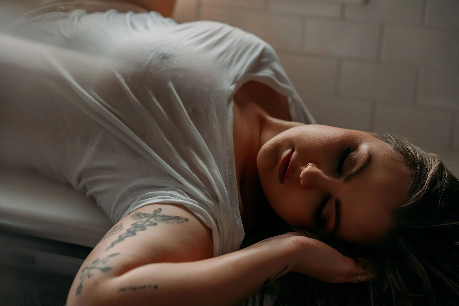 Woman lying on a counter in a wet white t-shirt, Wet T-Shirt add-on set in Nashville, TN