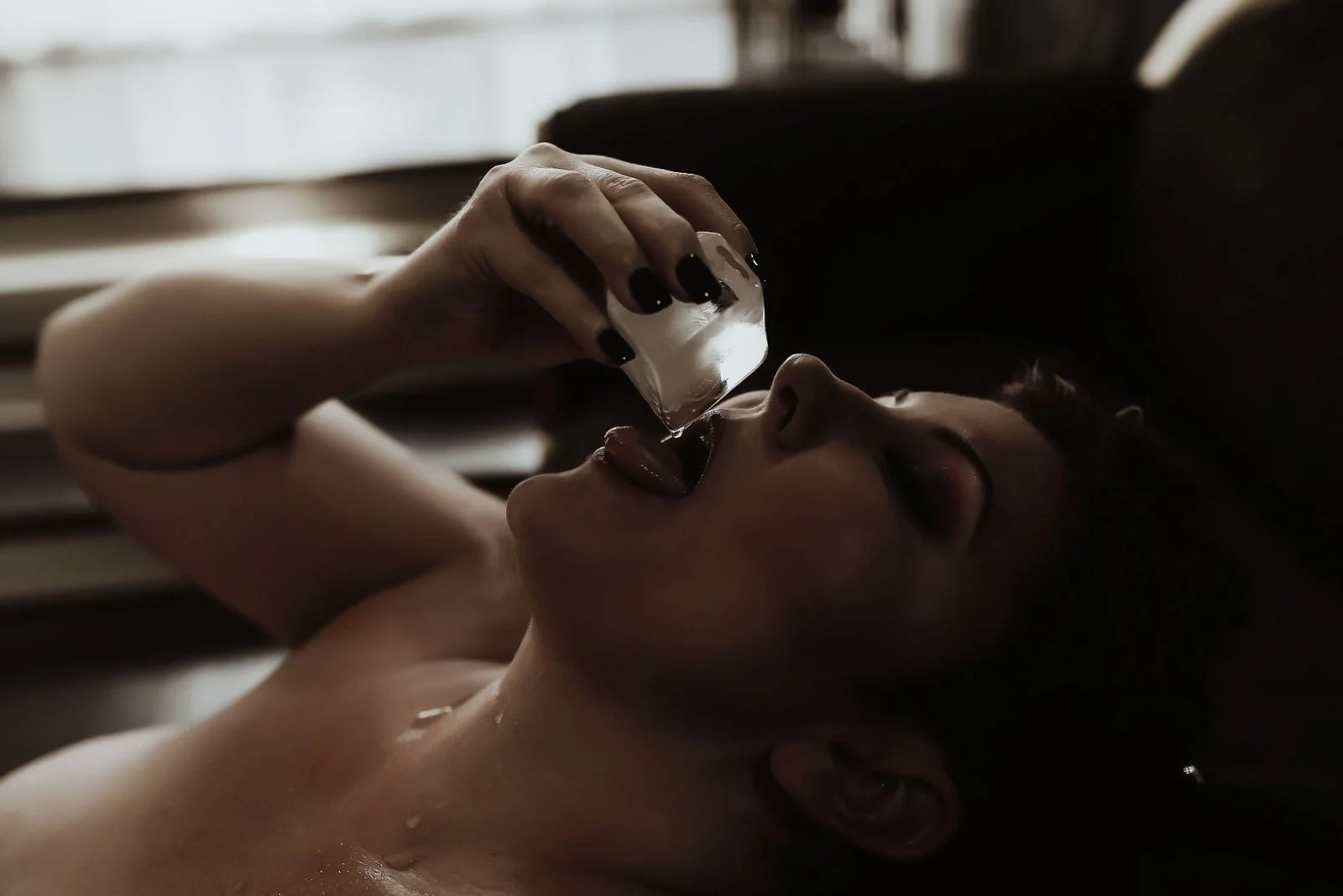 Woman on her back pouring syrup from a small glass into her mouth, Sticky Sweet add-on set by Nashville boudoir photographer Holly Douglas & Co