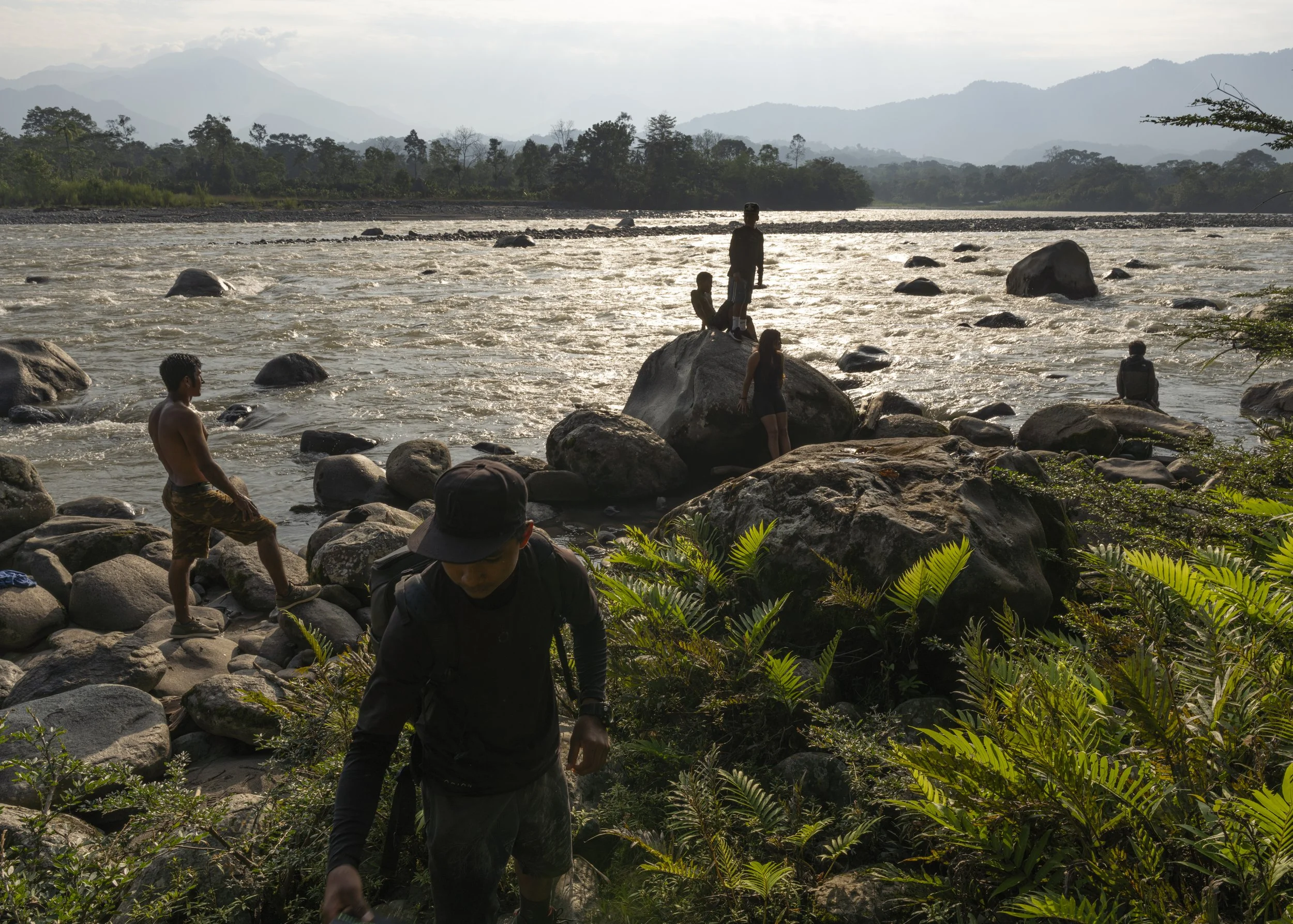 A group of local children gaze out over the upper reaches of the Jatunyaku River, one of the largest tributaries of the Napo River.