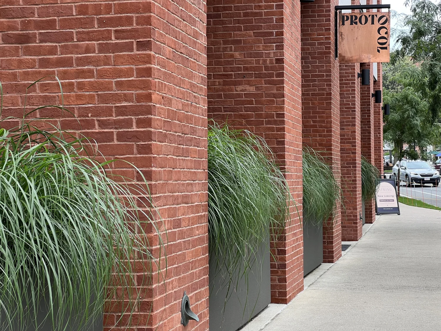 Protocol's brick storefront and copper sign on East Pleasant Street in Amherst