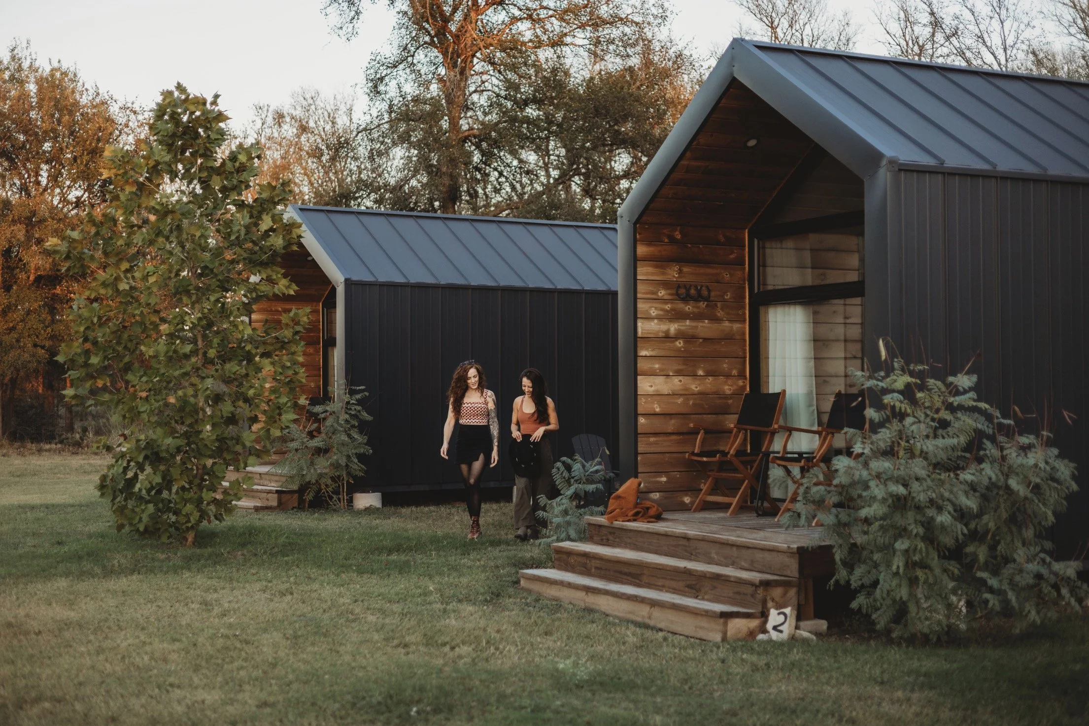 two girls standing beside the cabins at Rancho Moonrise
