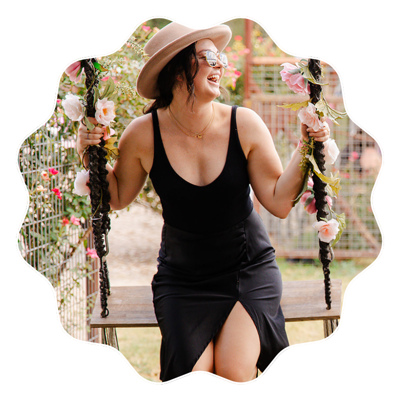 Female attendee of YouMeShe Fest on flower swing