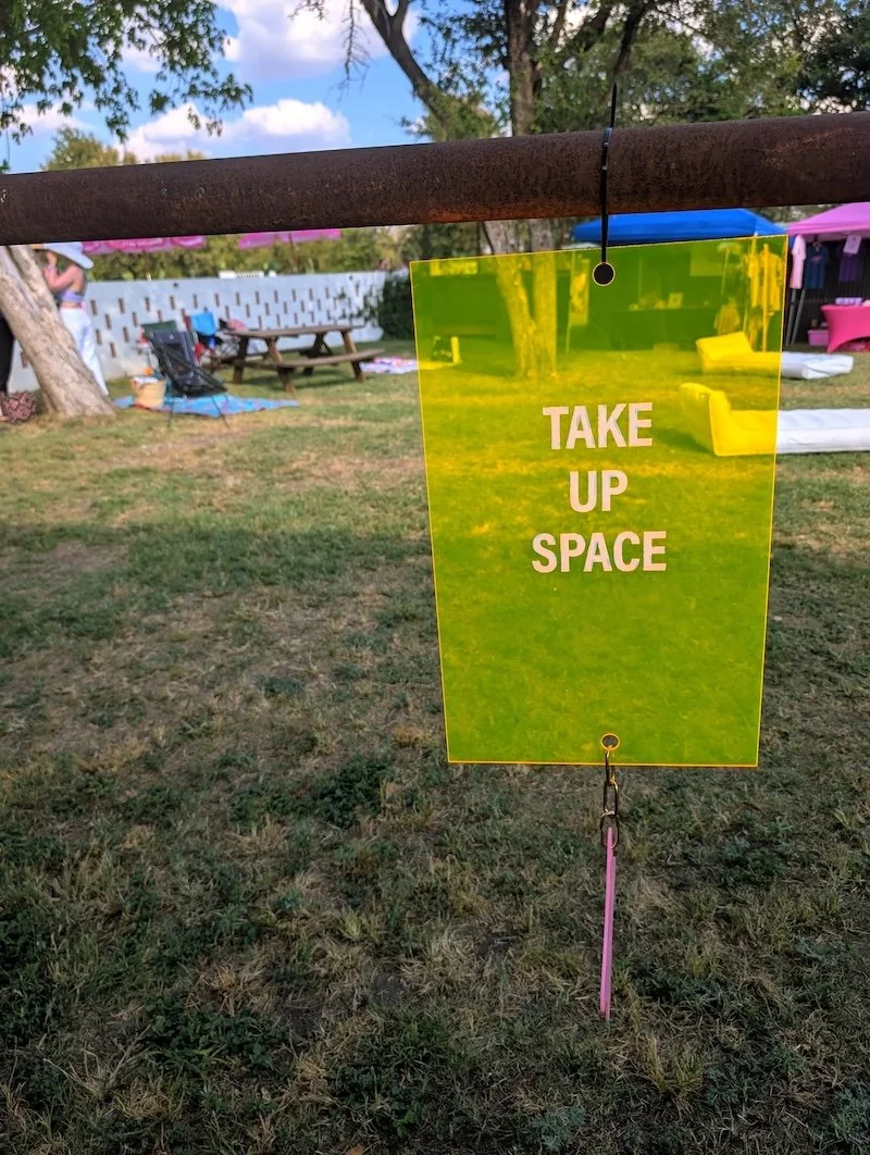 Take Up Space sign at YouMeShe Festival