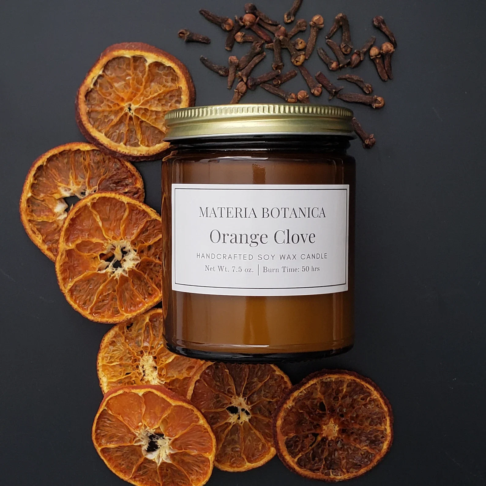 a jar candle in a citrus clove scent.