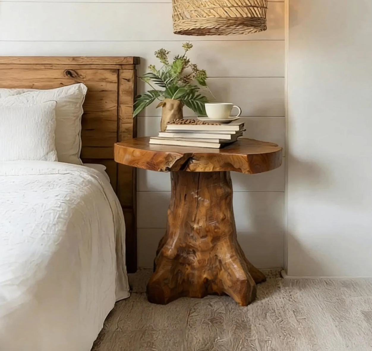 a small coastal farmhouse bedroom with a tree trunk style side table.