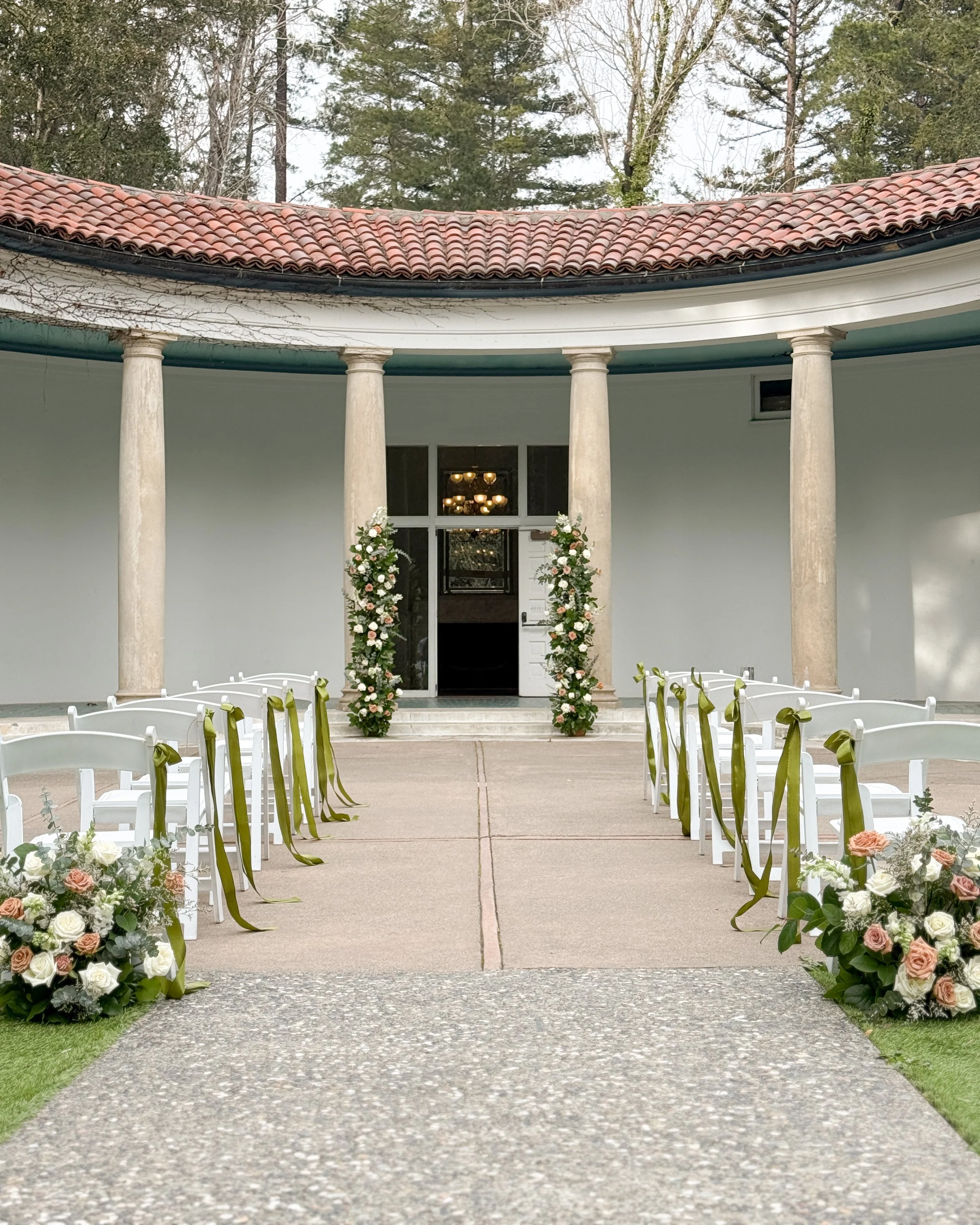 Wedding ceremony flowers with white playa blanca roses and toffee roses