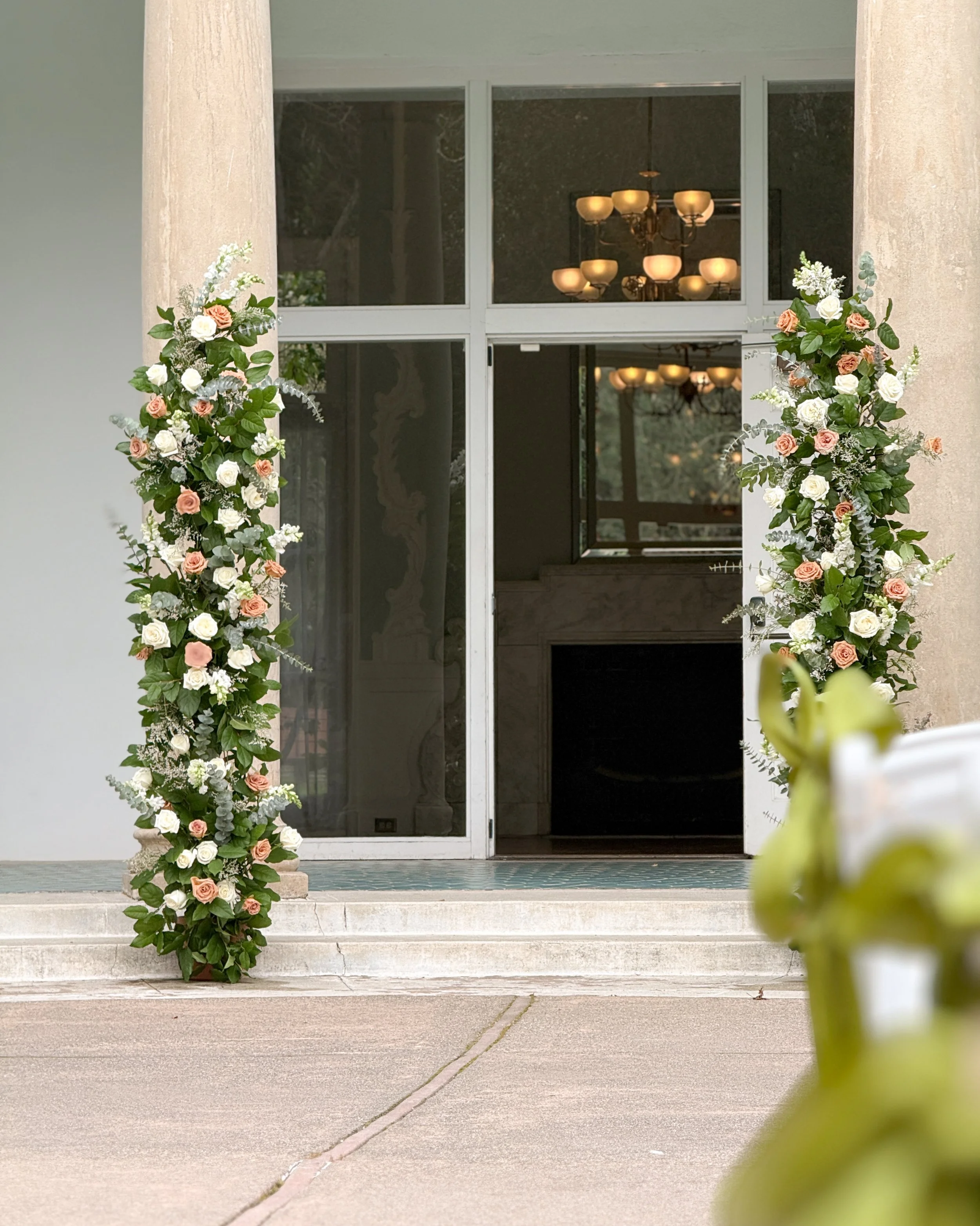 Wedding ceremony flower columns with white playa blanca roses and toffee roses