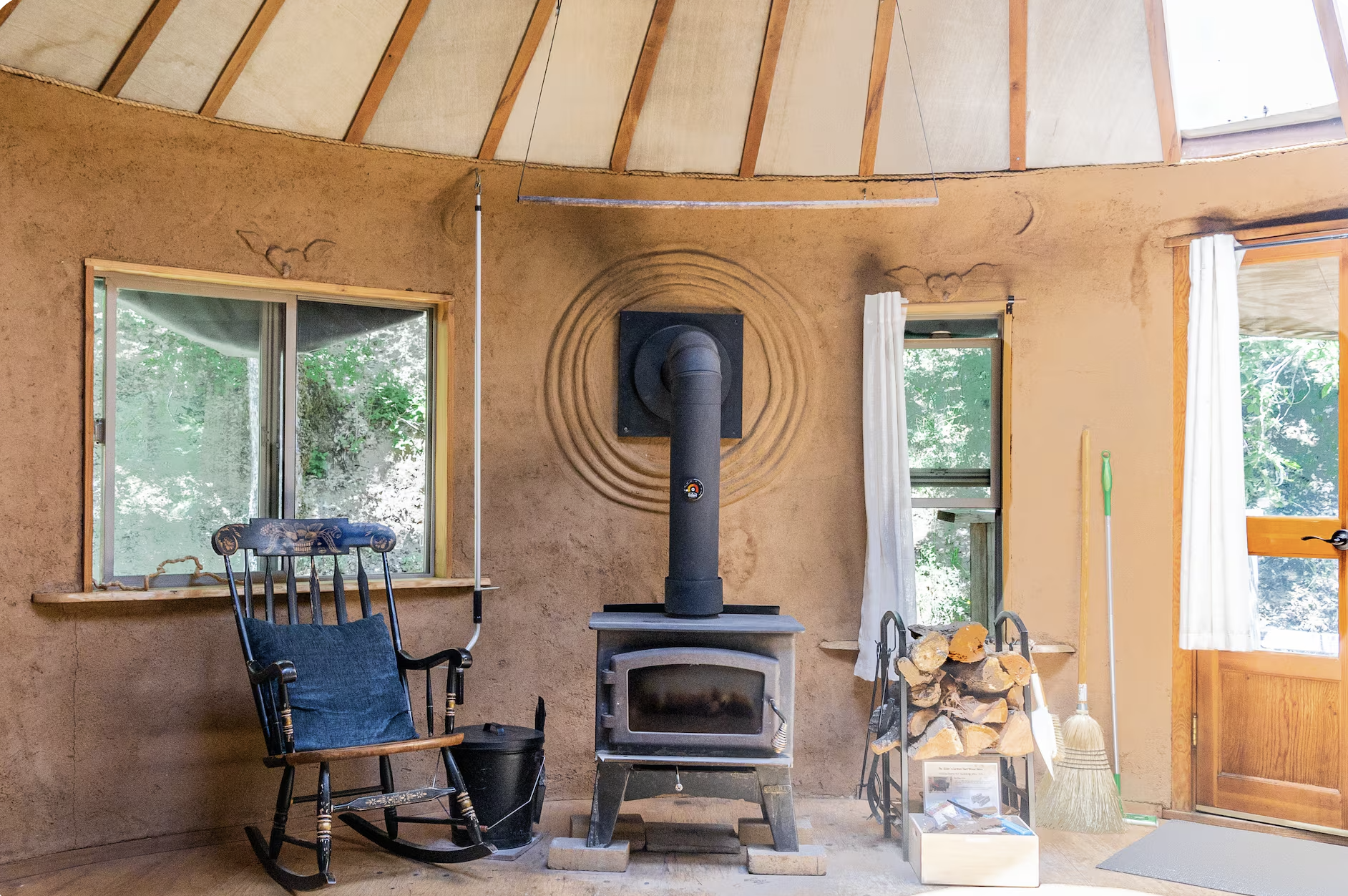 The Earthen Yurt ~ Drift into dreams beneath the captivating Tree of Life headboard, surrounded by lunar cycles adorning the interior walls.