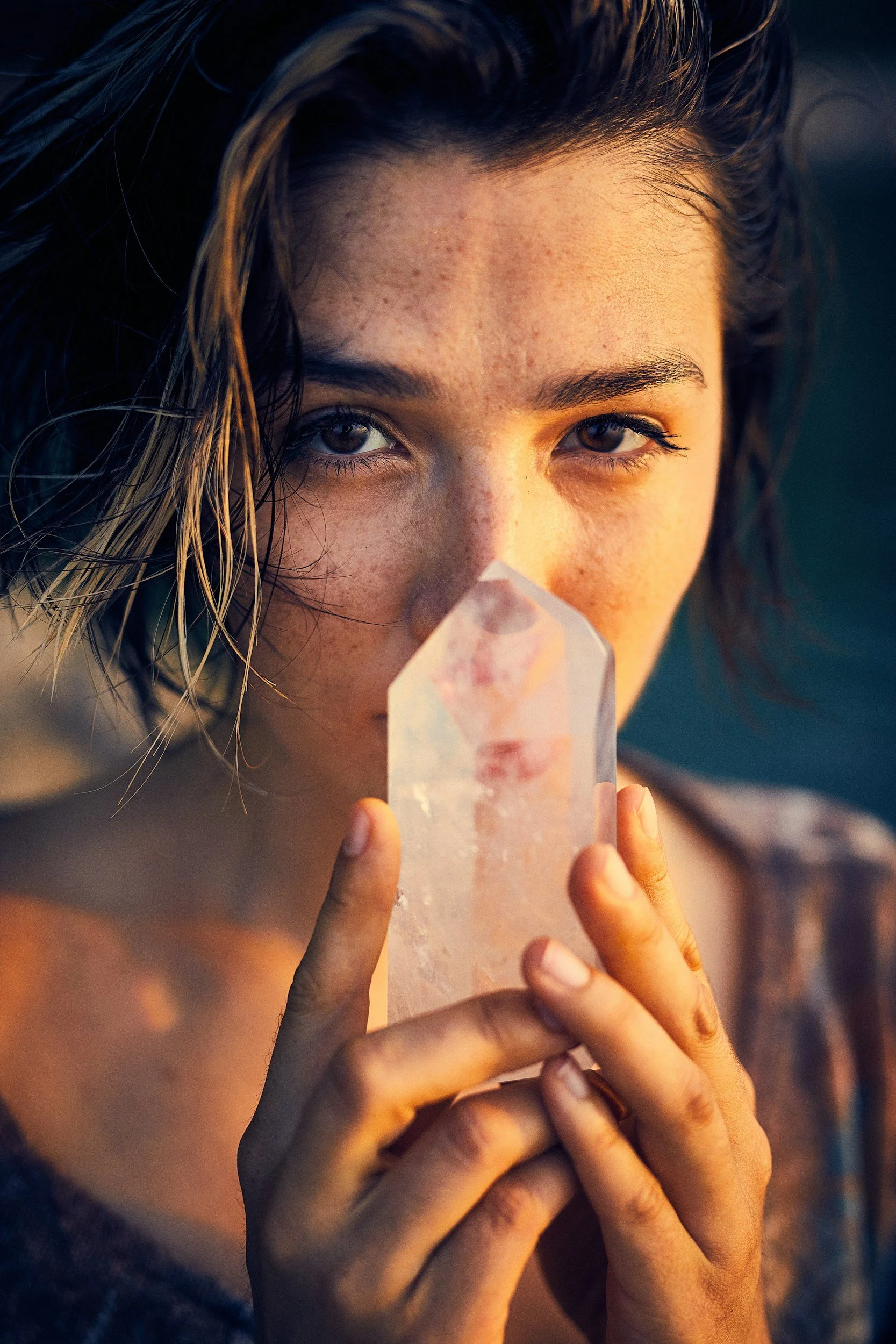 Woman holding a crystal during a manifestation and embodiment workshop exploring desire at a women’s spiritual retreat in Northern California.