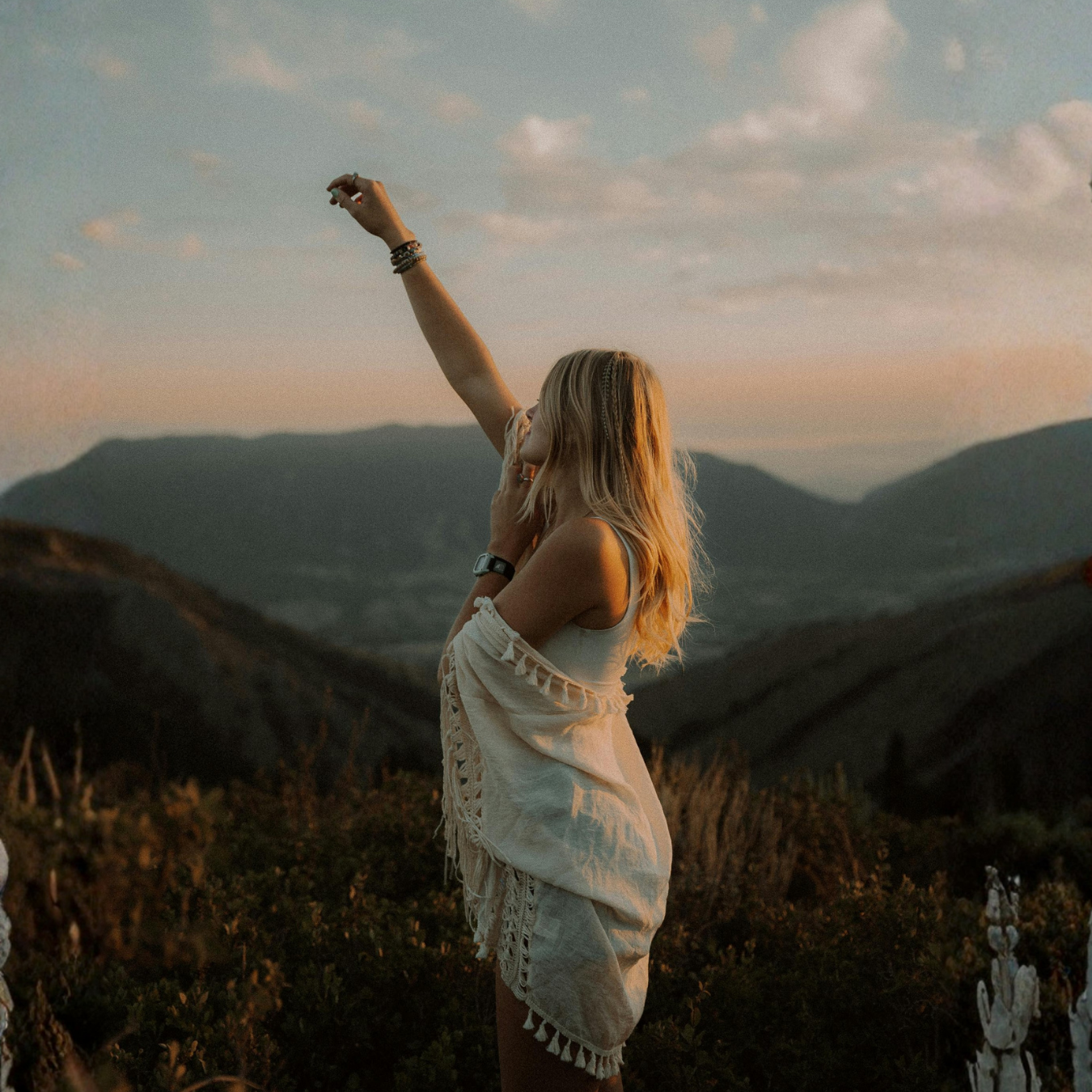 Woman connecting with nature in the mountains during a spiritual women’s retreat in Northern California.