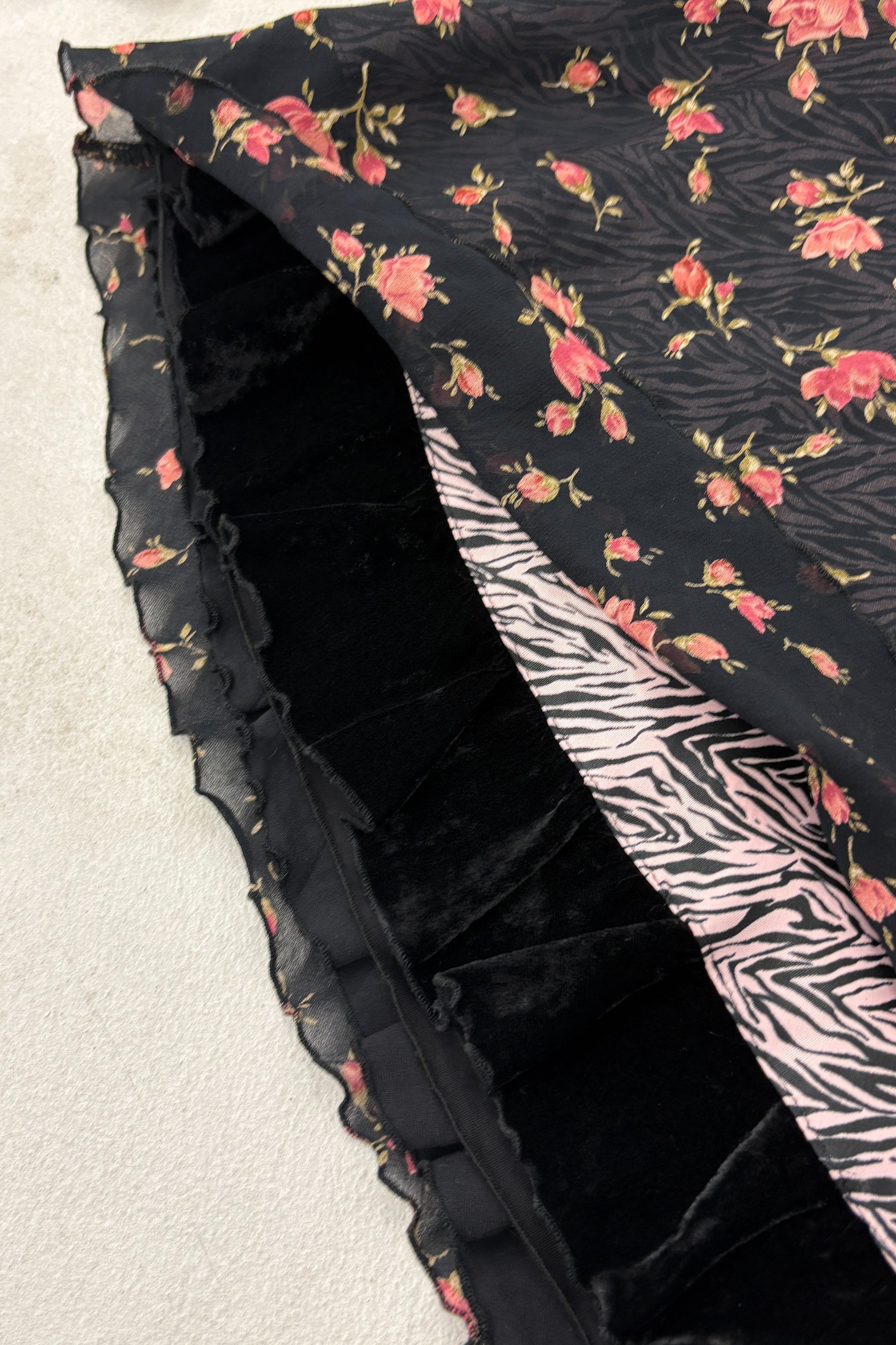 A flat lay of an Italian Y2K midi skirt with two layers, highlighting the textured fabric and layered effect.