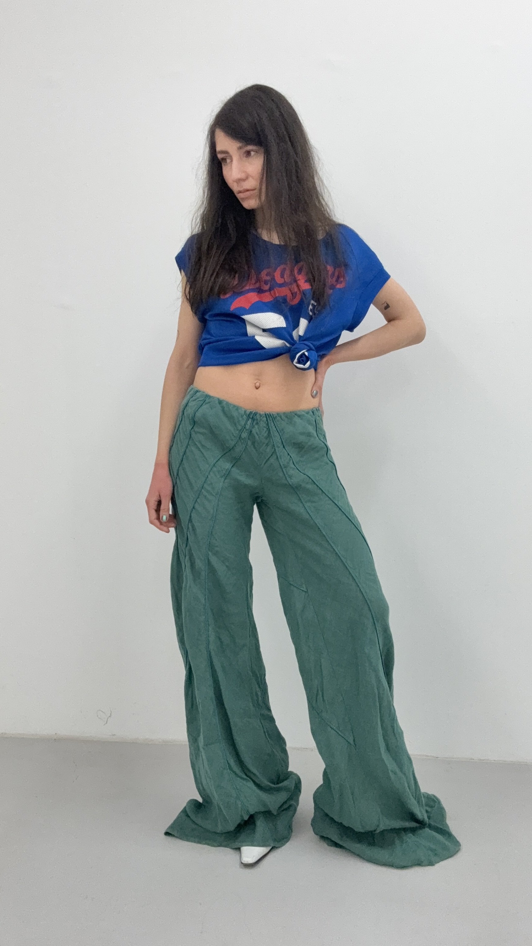 A full shot of Italian oversized green trousers with a loose, breezy silhouette for a laid-back look.